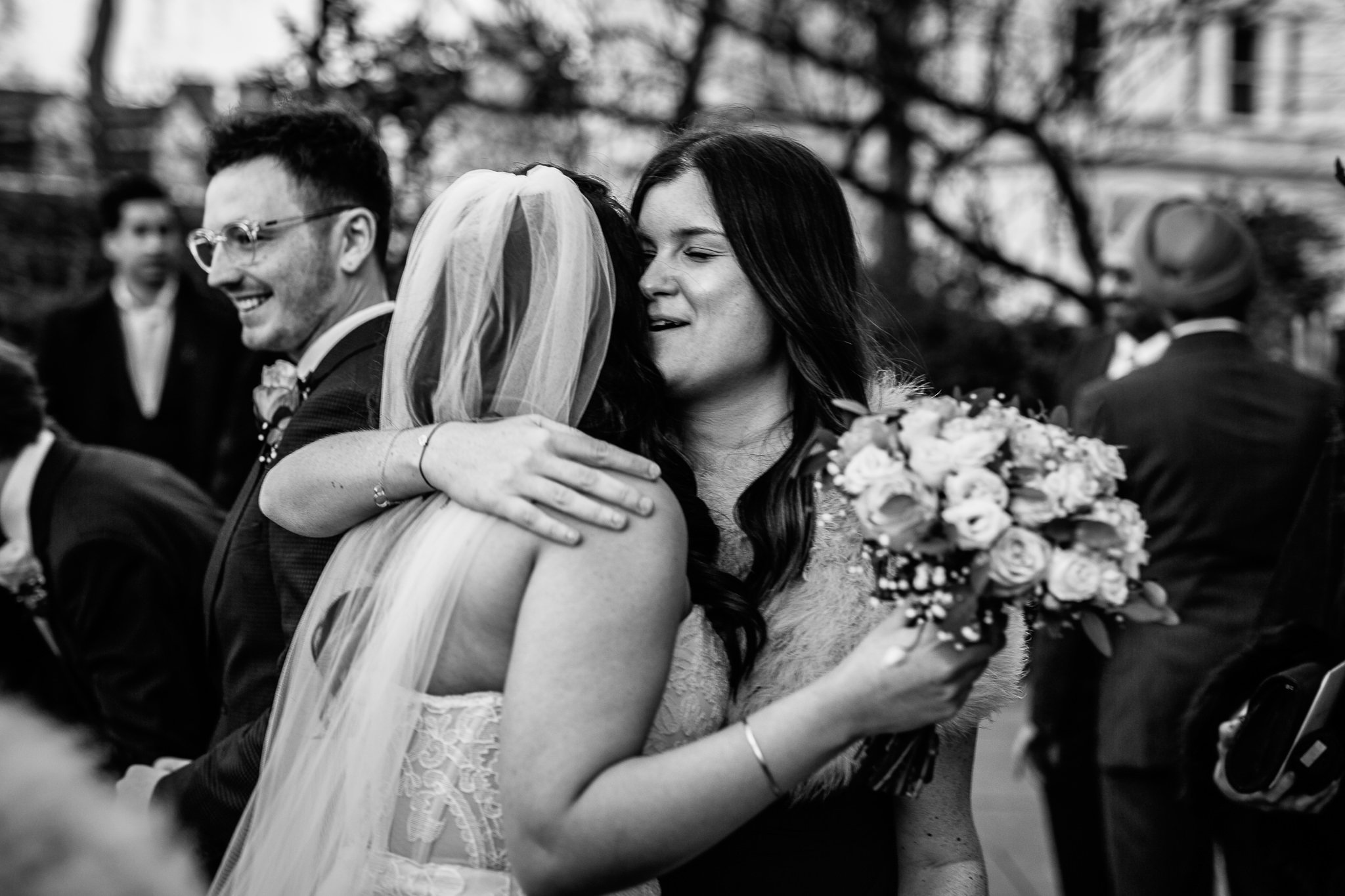  Wedding guest hugs the Bride outside St Stephen’s Trust Hampstead London 