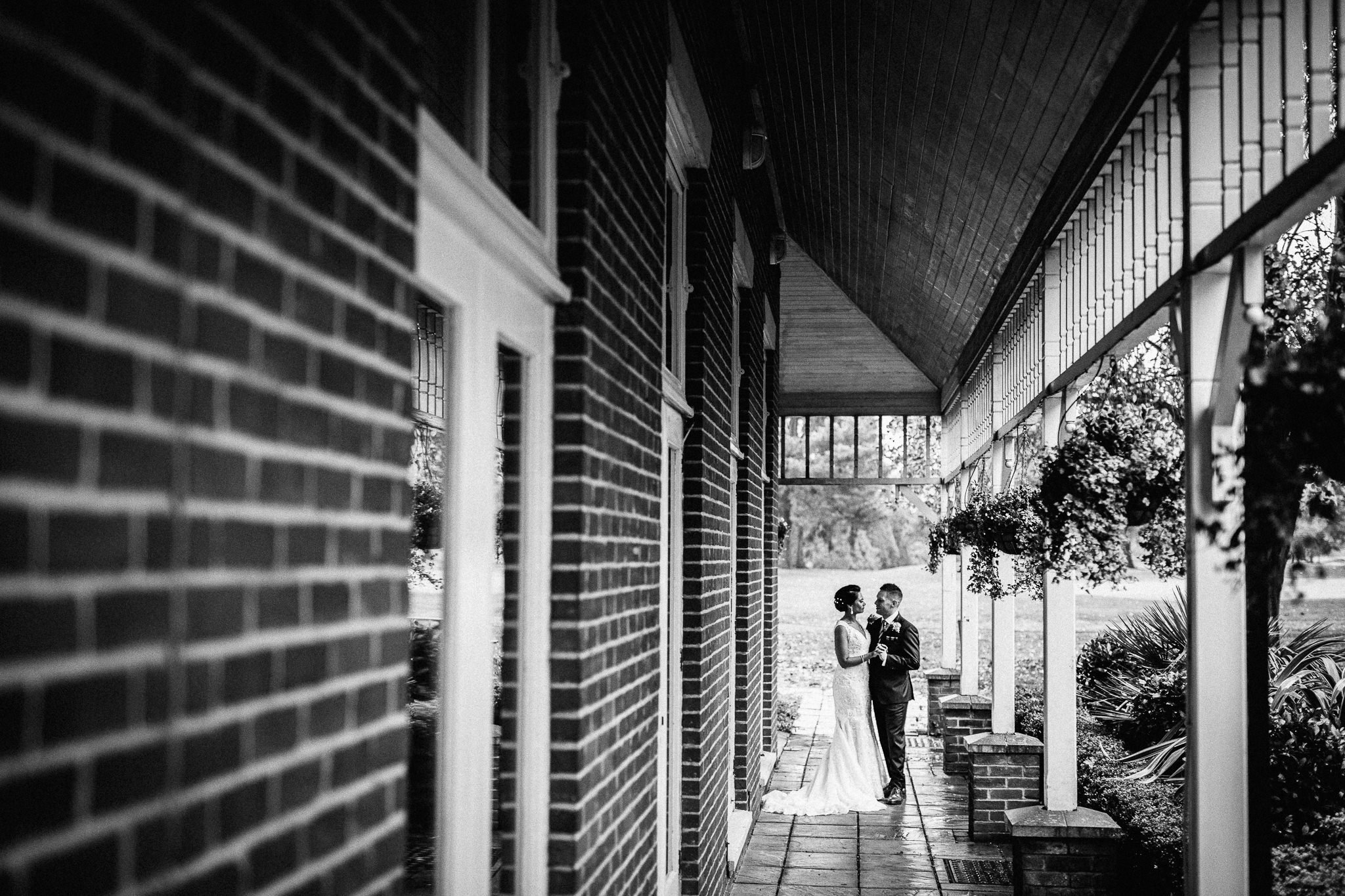  Bride and Groom hugging outside Coulsdon Manor Hotel 
