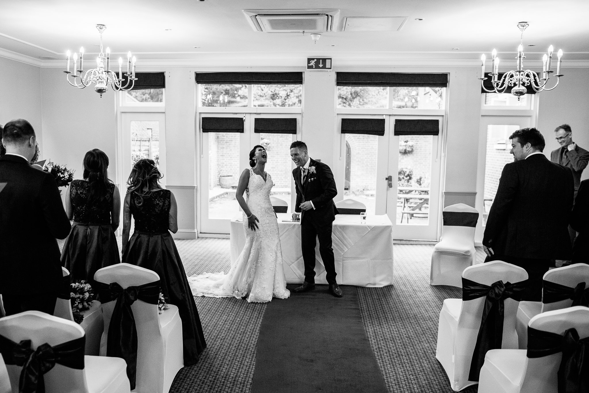  Bride and Groom laughing during their wedding ceremony 