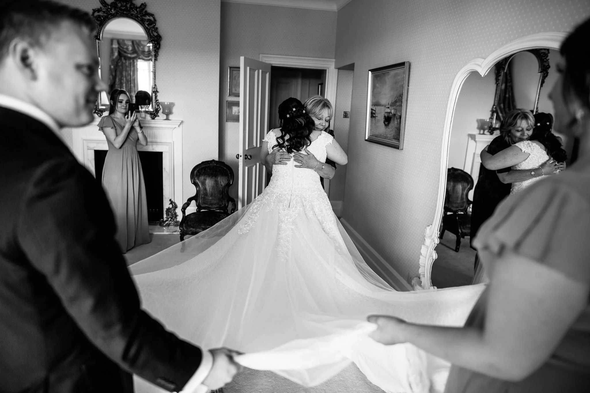  Mother of the Bride hugs her daughter at Wadhurst Castle 
