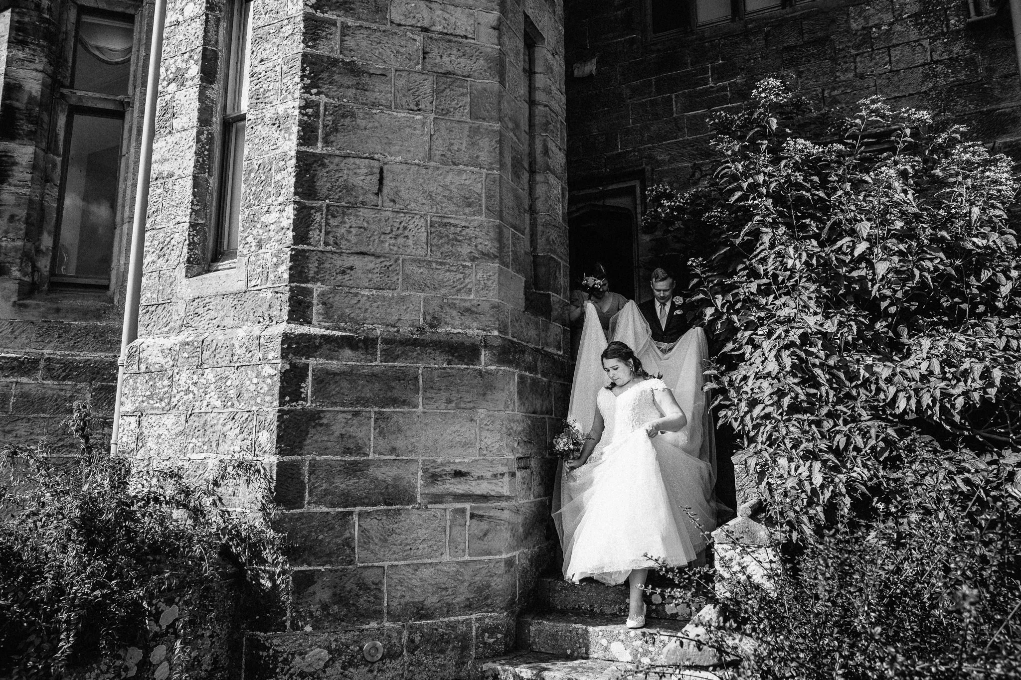  Bride walking down the steps outside Wadhurst Castle 