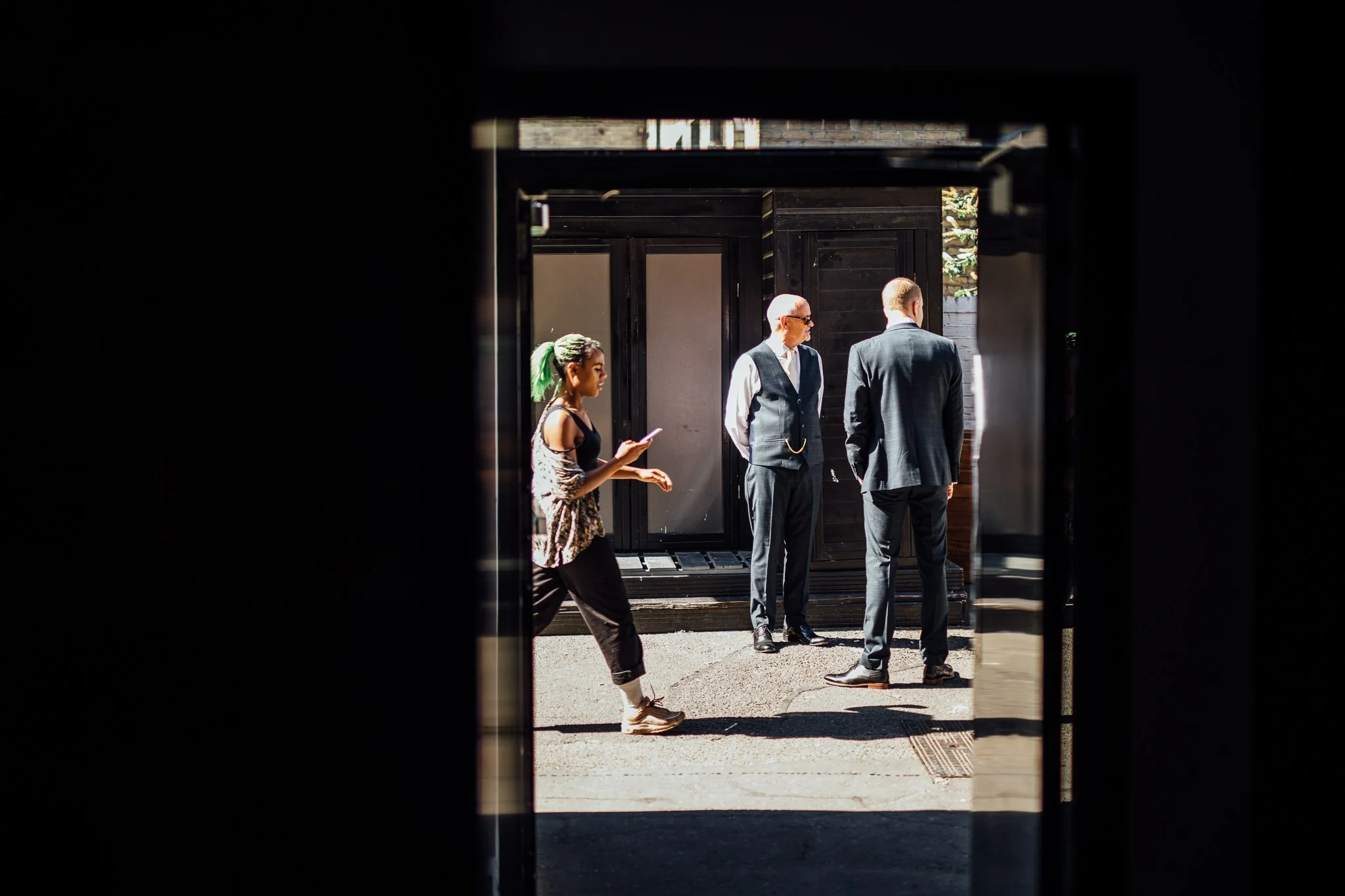  Two men wait outside Shoreditch Studios 