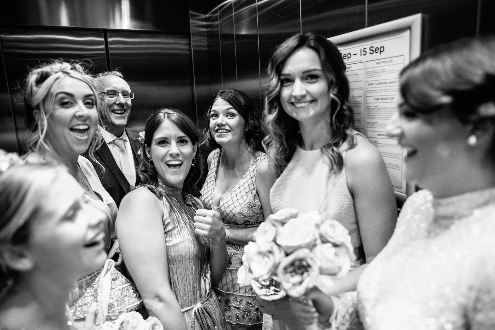  Bridal party ina lift smiling and waving 