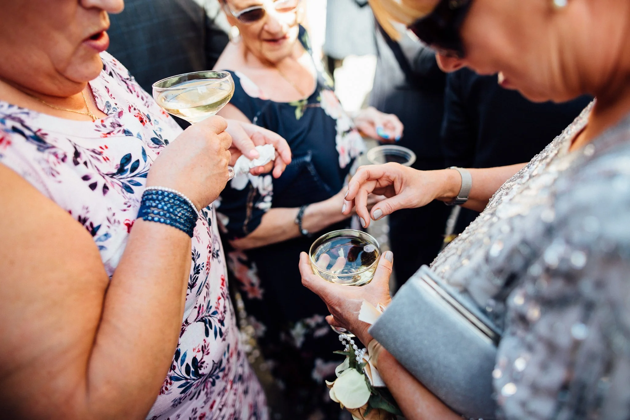  Guest picks a piece of confetti out of their champagne. 