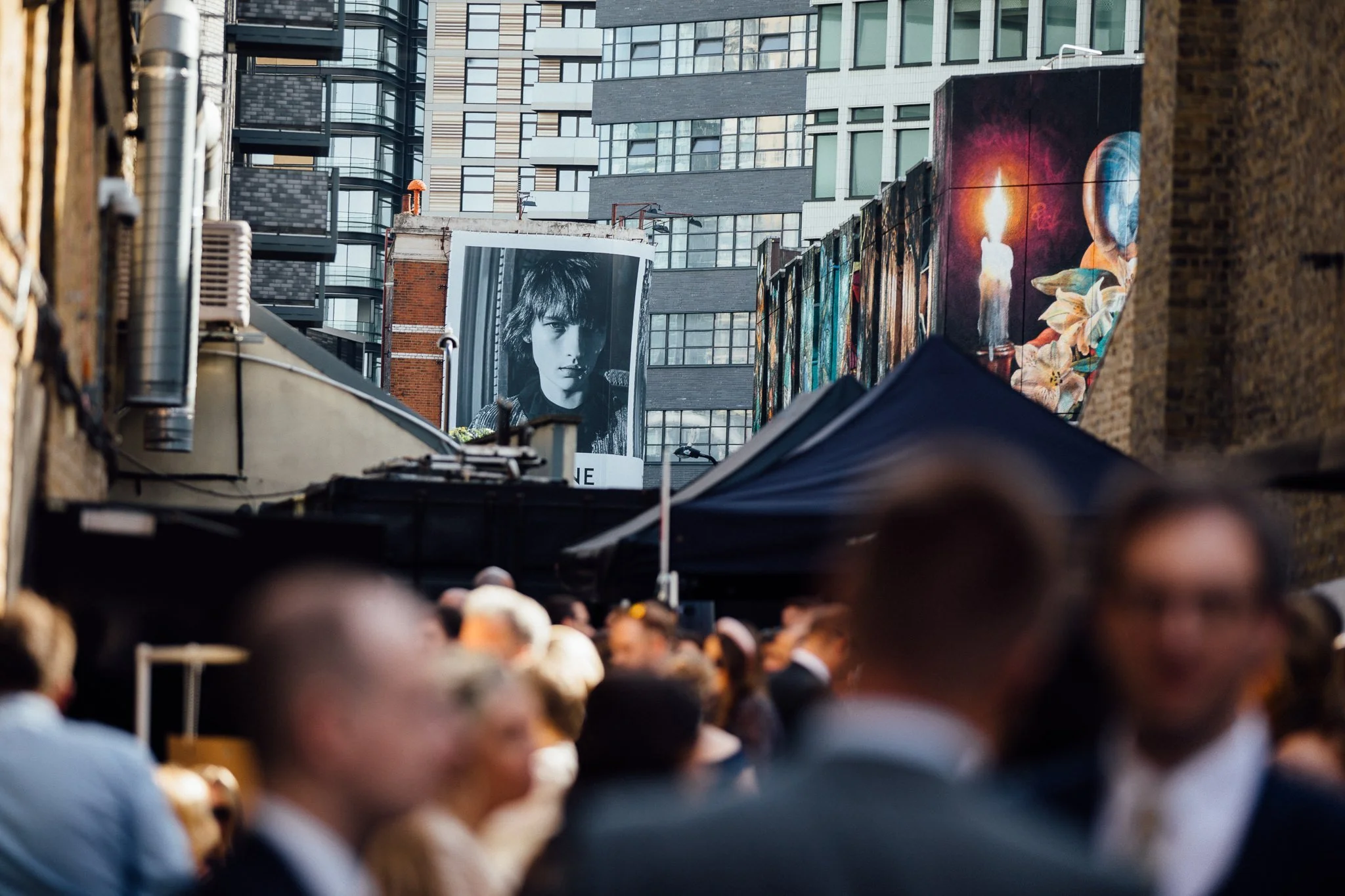 Advertising in the background with wedding guests in the foreground. 