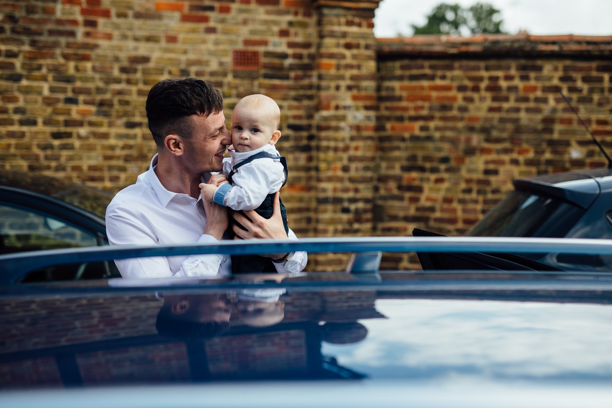  Groom touching heads with his son. 