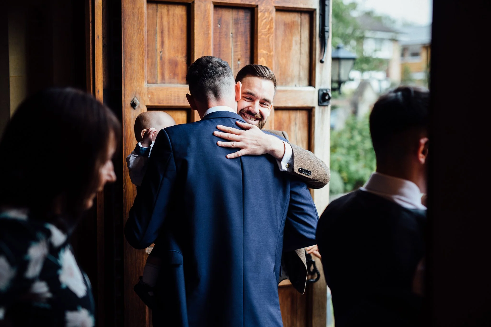  Groom hugging a guest 