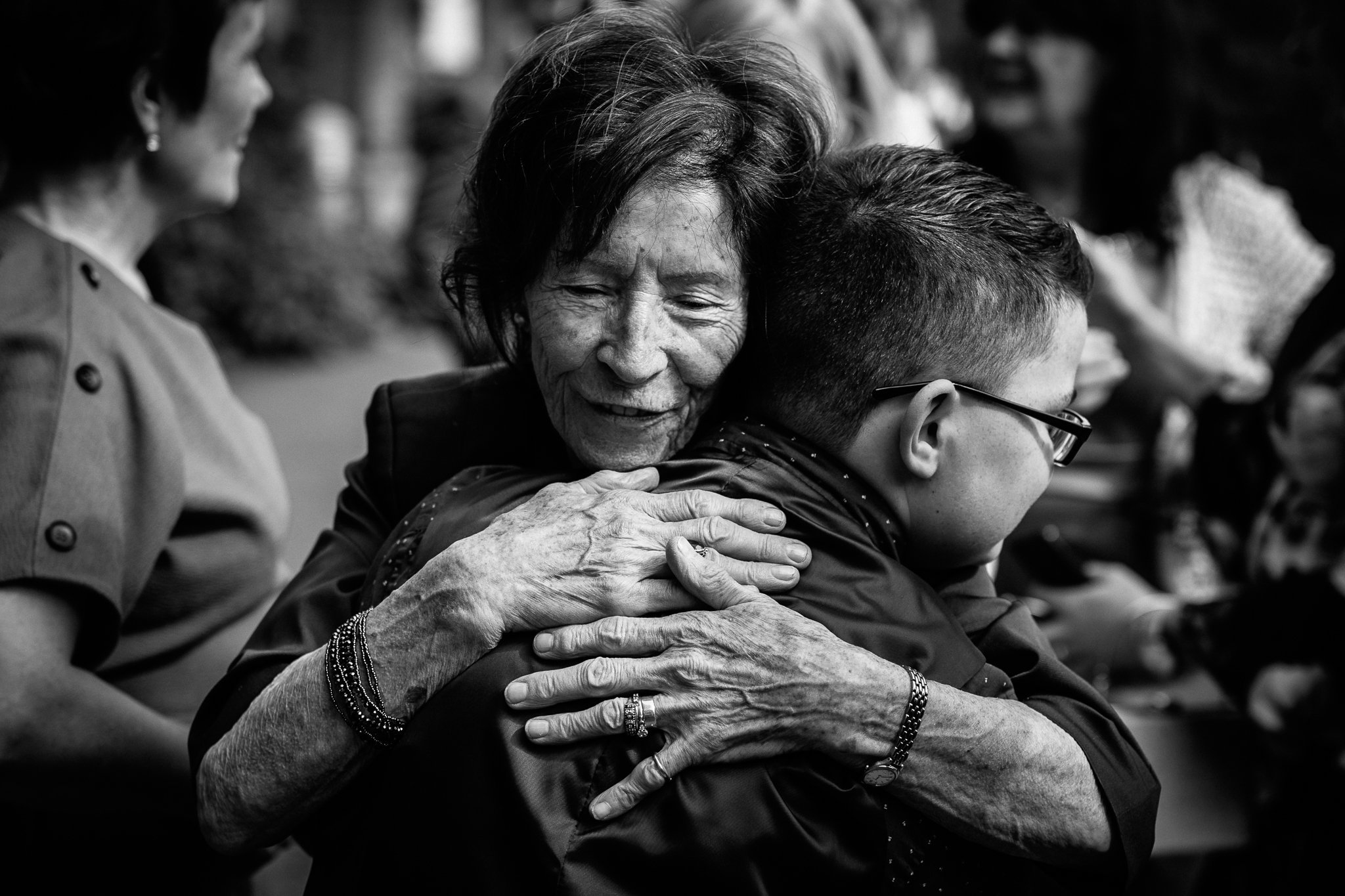  Lady hugs a young boy outside The Holy Family Church in Reigate 