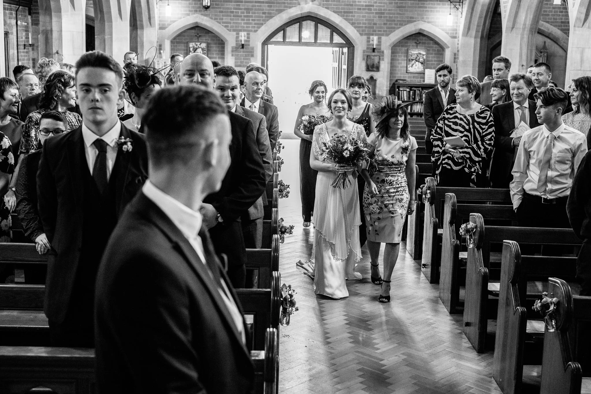  Bride walking down the aisle at The Holy Family Church in Reigate 