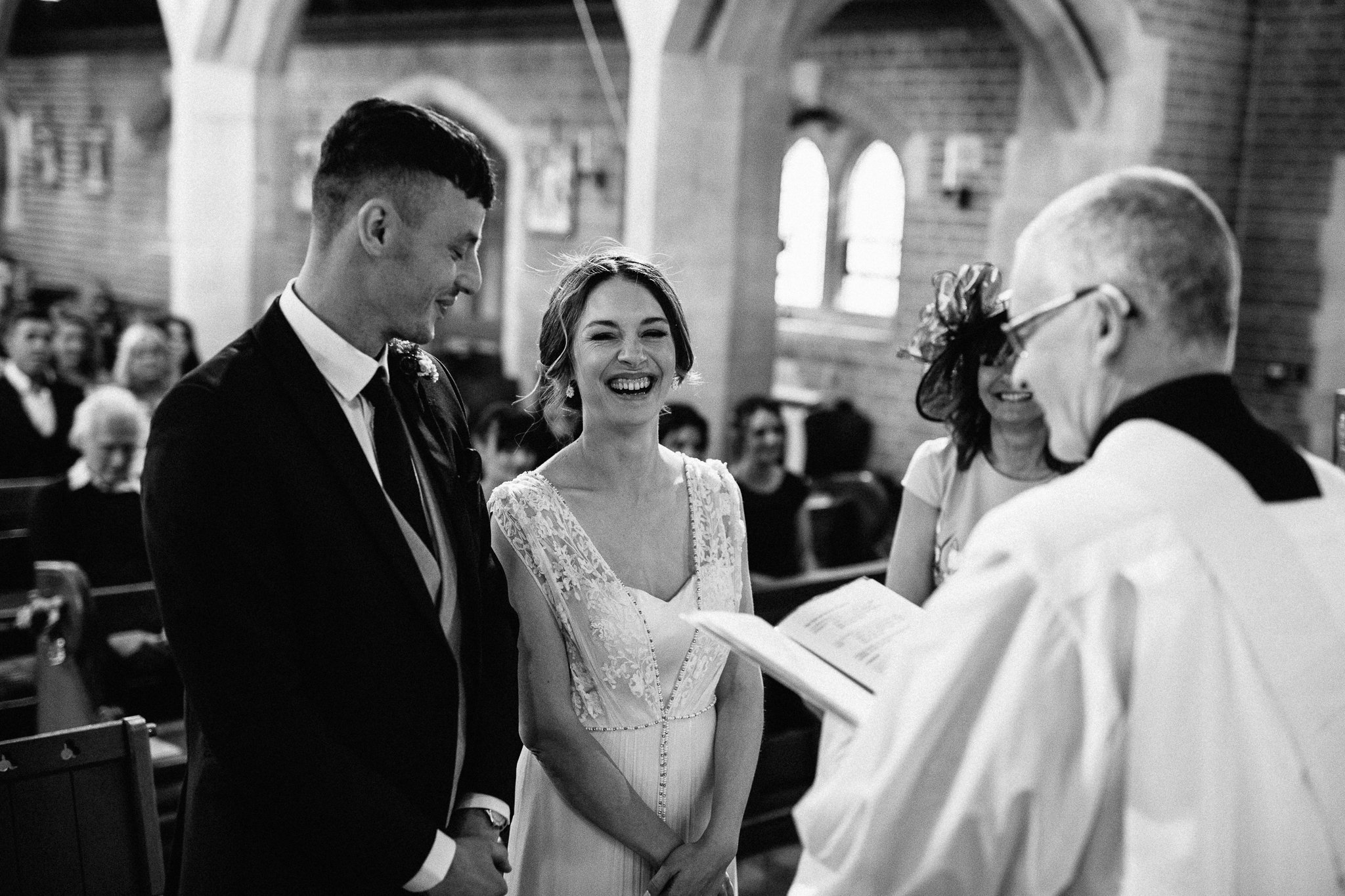  The bride with a big smile on her face at The Holy Family Church in Reigate 