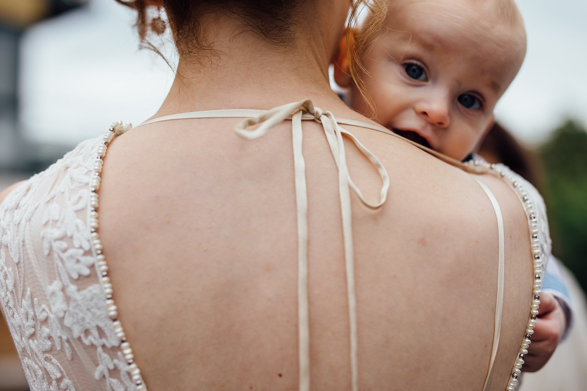  Baby boy looks over his mum’s shoulder 