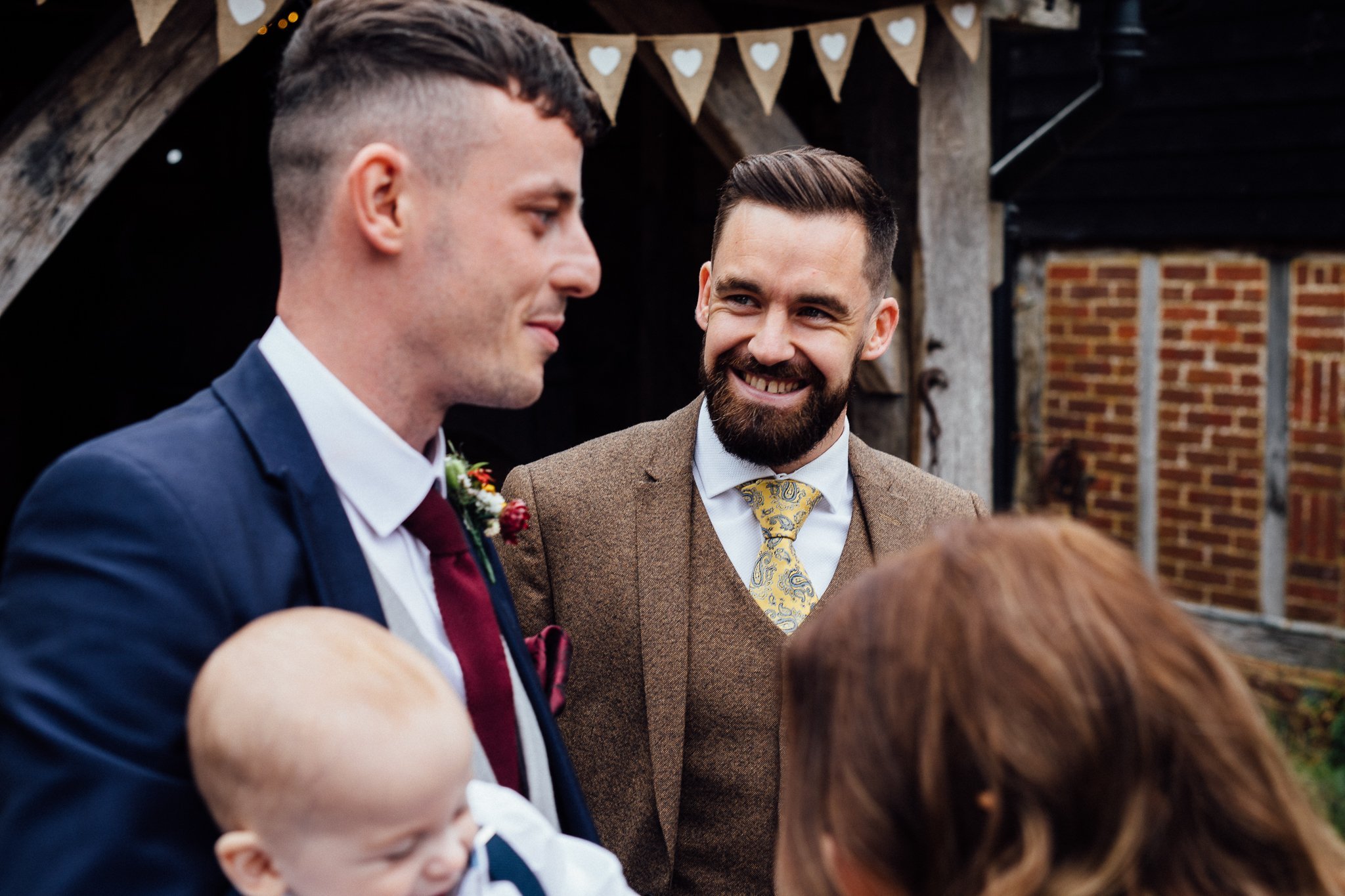  Well dressed wedding guest looks at the groom 