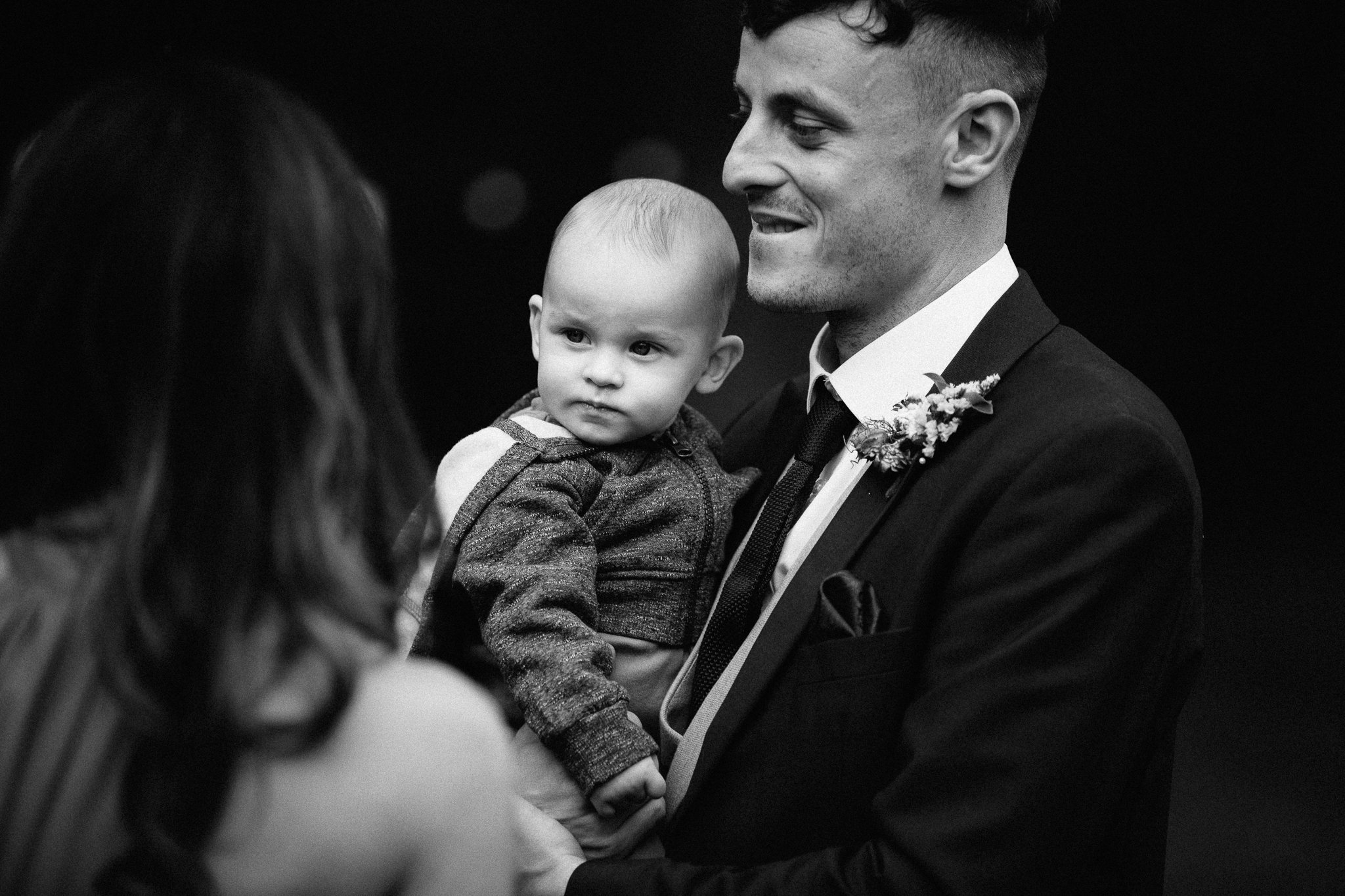  Groom holds a baby 