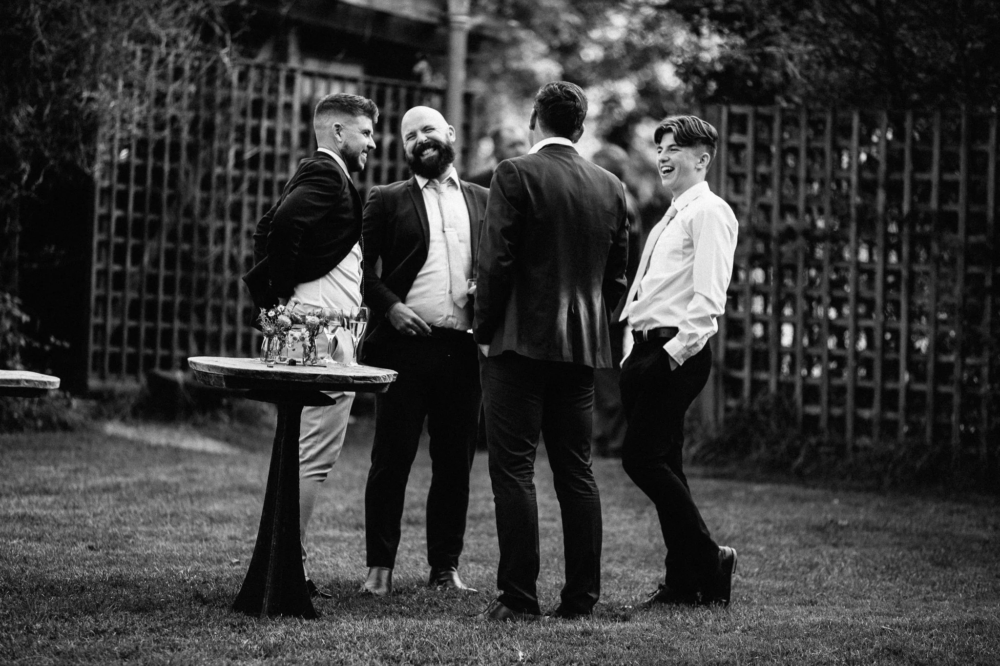  A group of men laughing and joking at Gildings Barns in Newdigate Surrey 
