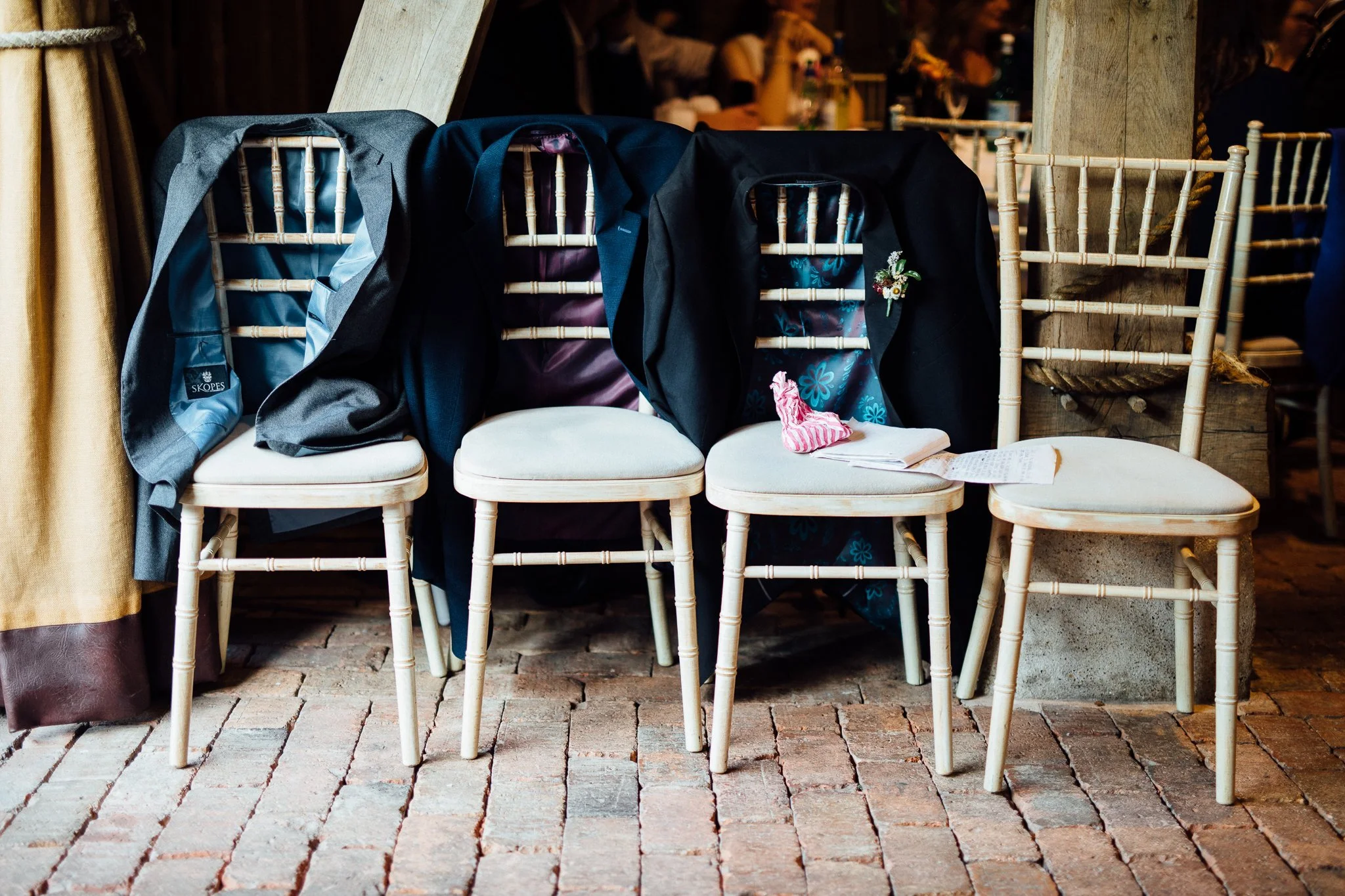  Jackets resting over the back of chairs at Gildings Barns in Newdigate Surrey 