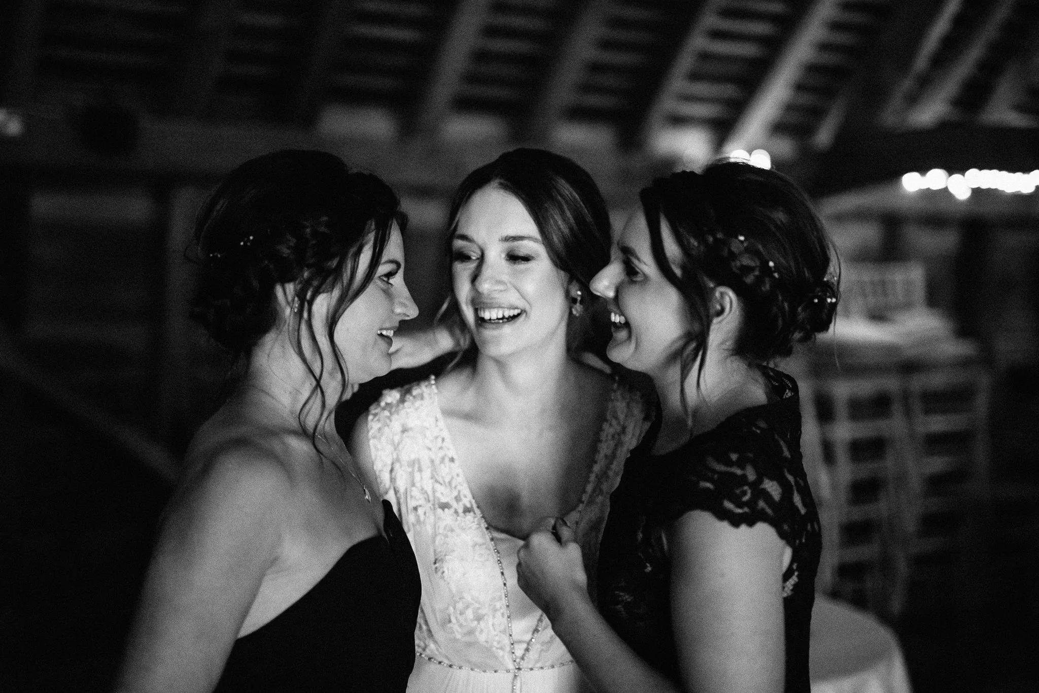  The bride and her friends hug at Gildings Barns in Newdigate Surrey 