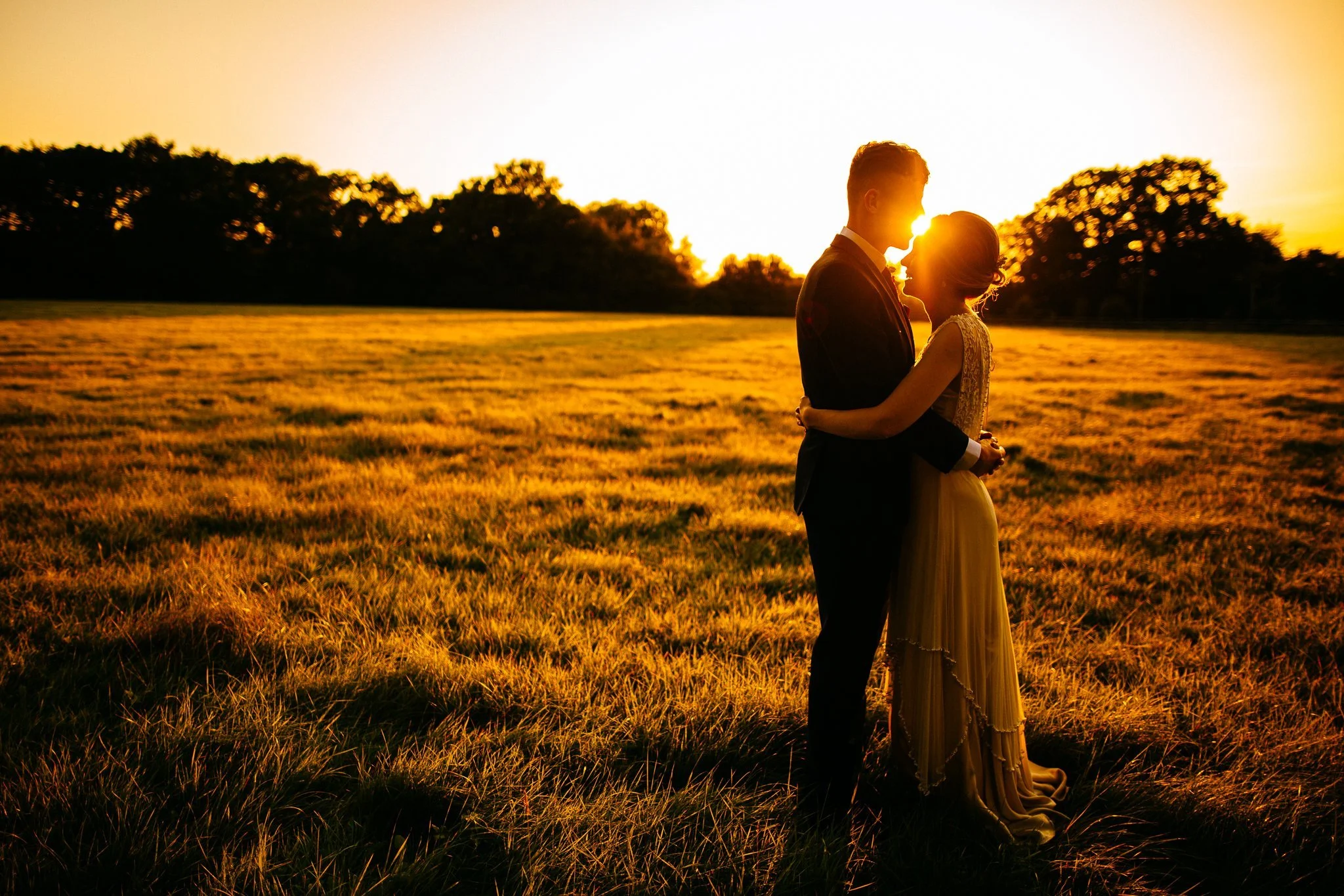  Groom kisses the Bride on the forehead at Gildings Barns in Newdigate Surrey 