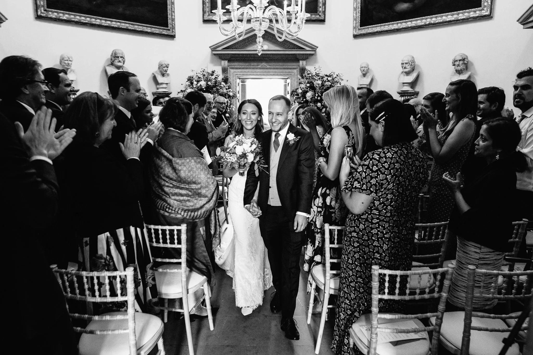  Bride and Groom walk down the aisle at Chiswick House after getting married  