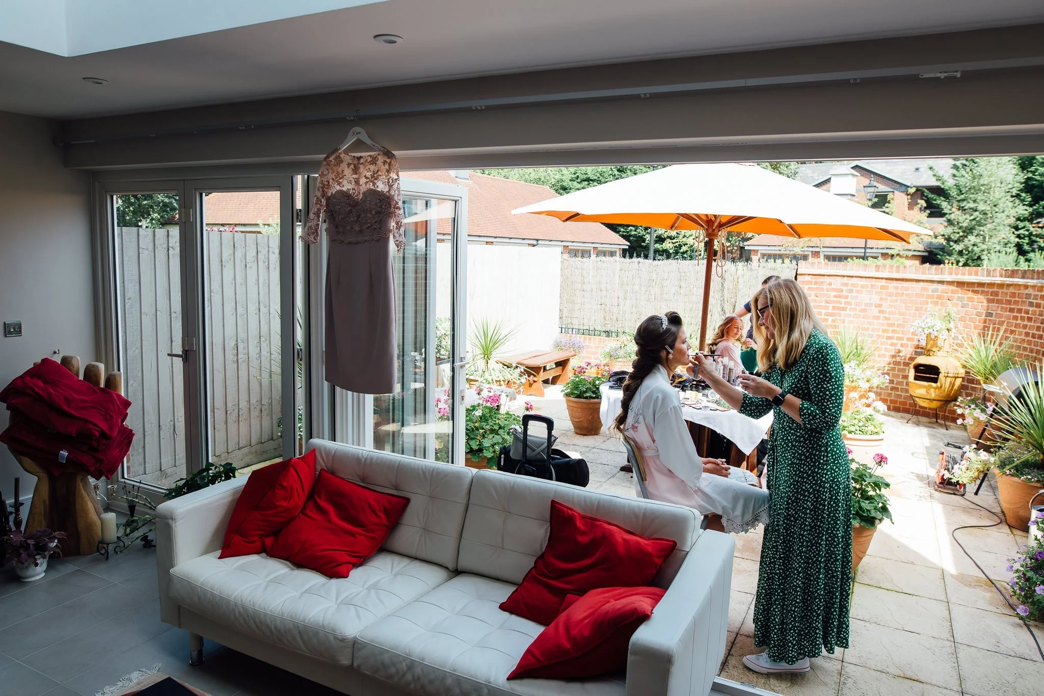  Bride has makeup applied in her family home 