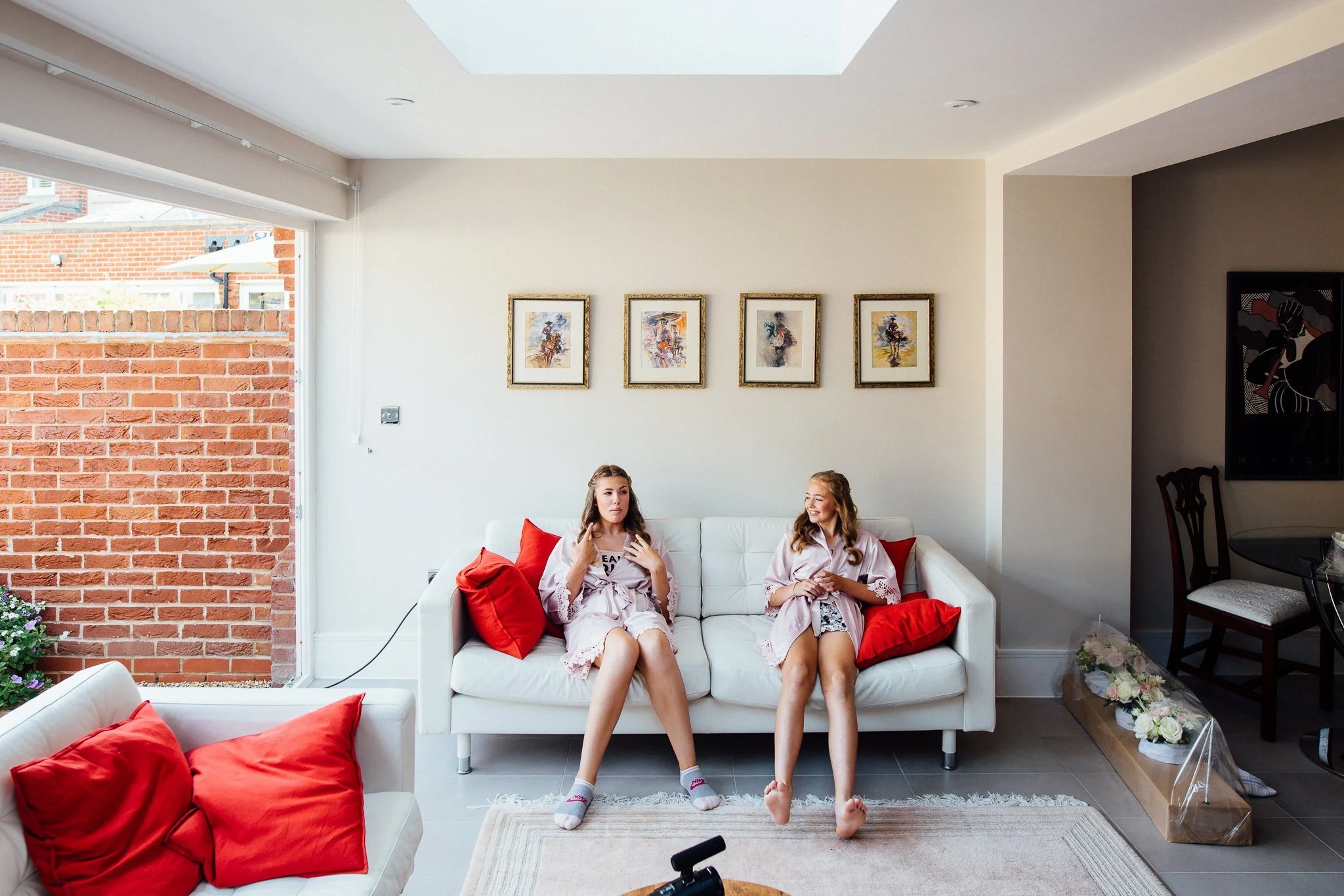  Bridesmaids sit on a sofa waiting for the Bride 