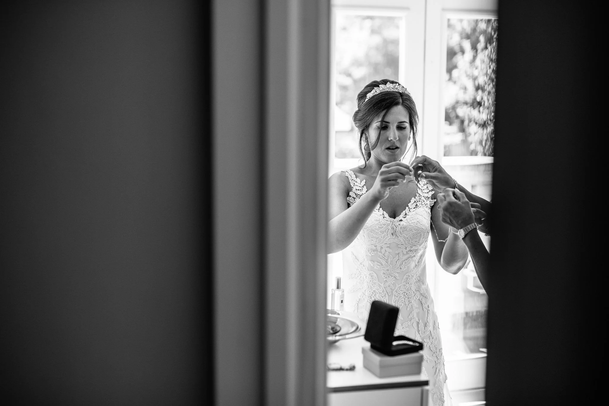  Bride trying to put her necklace on 