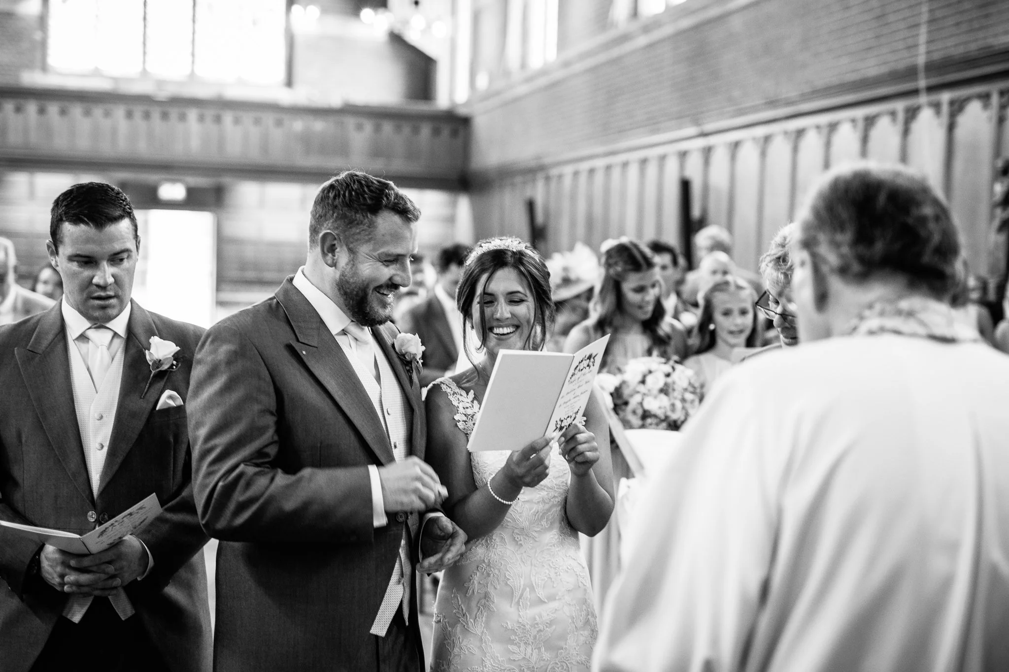  Bride and Groom singing a hymn  at the Chapel of St Luke at Epsom College 
