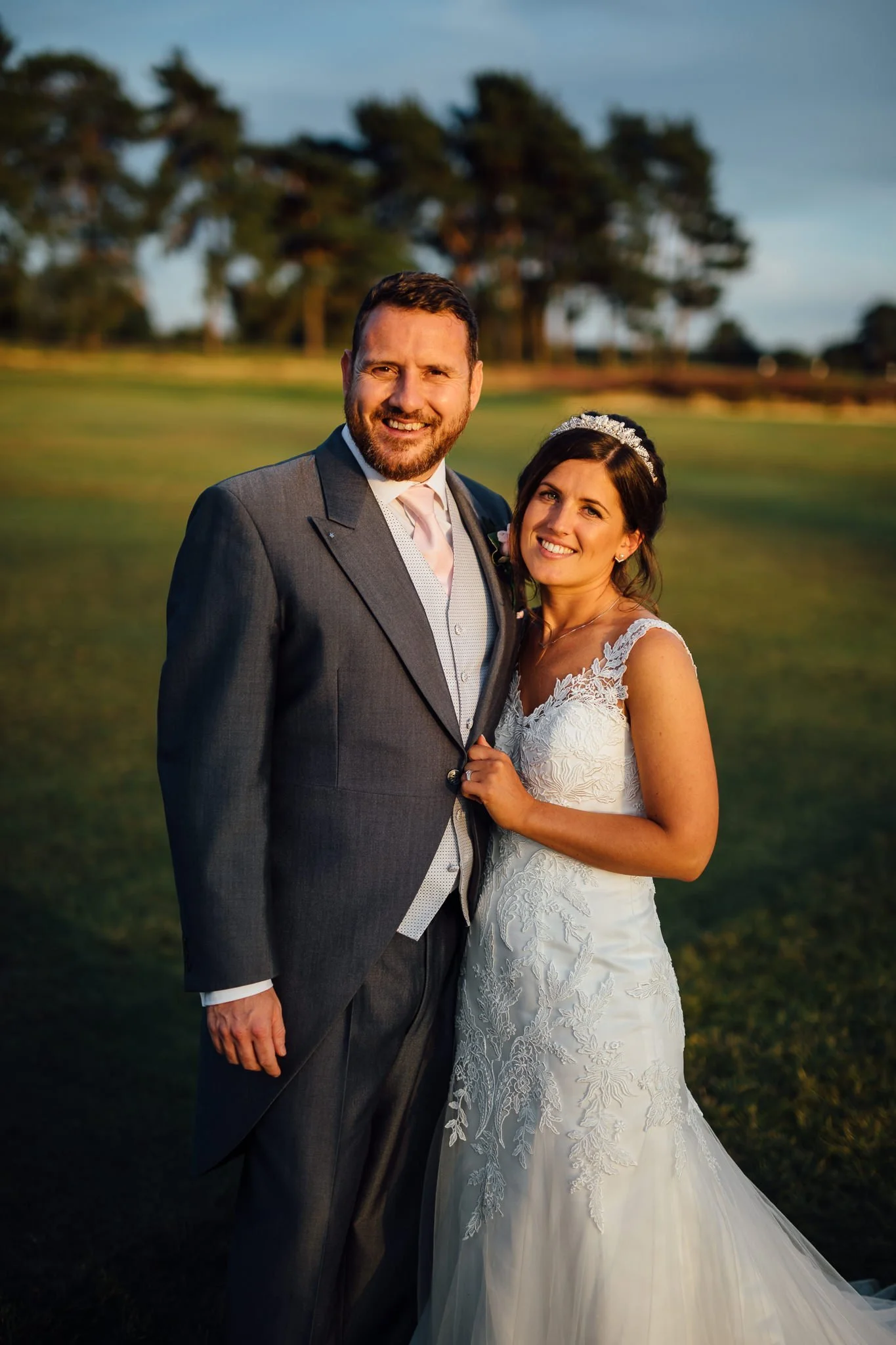  Bride and Groom pose for a photo on the golf course  at Walton Heath Golf Club Surrey 