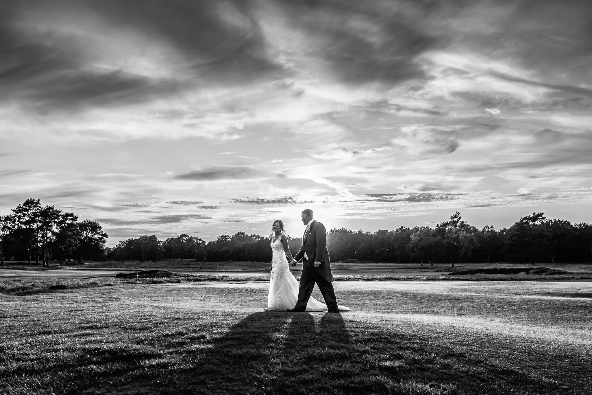  Bride and Groom laughing on the golf course  at Walton Heath Golf Club Surrey 