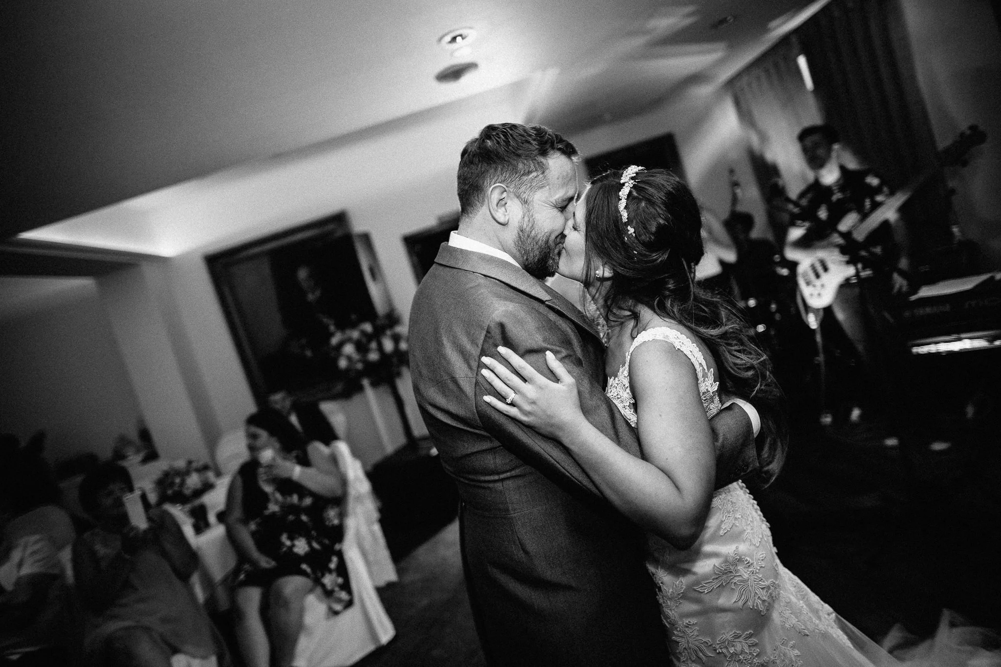  Bride and Groom kissing during their first dance  at Walton Heath Golf Club Surrey 