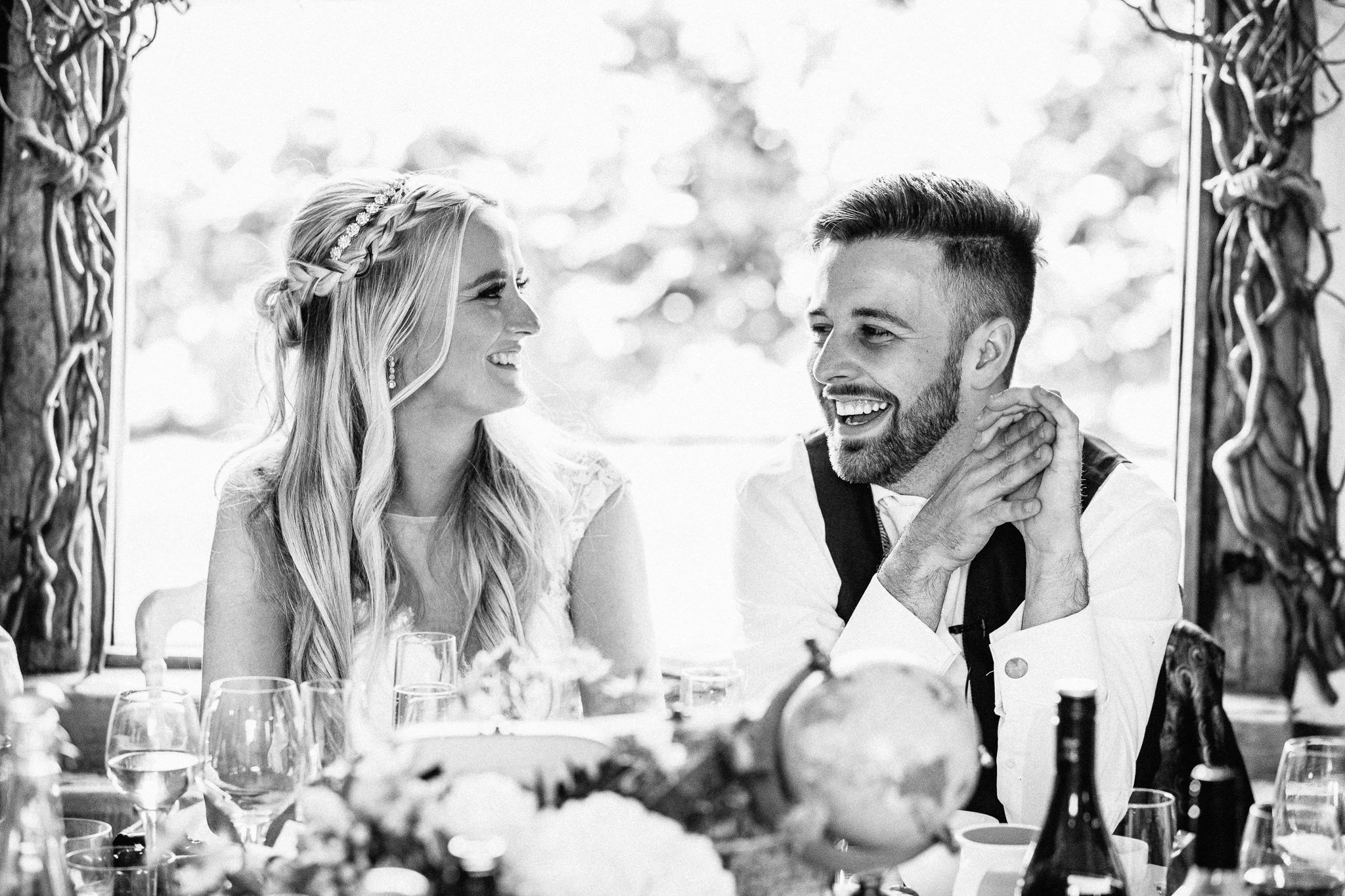  Bride and groom smiling during the speeches 