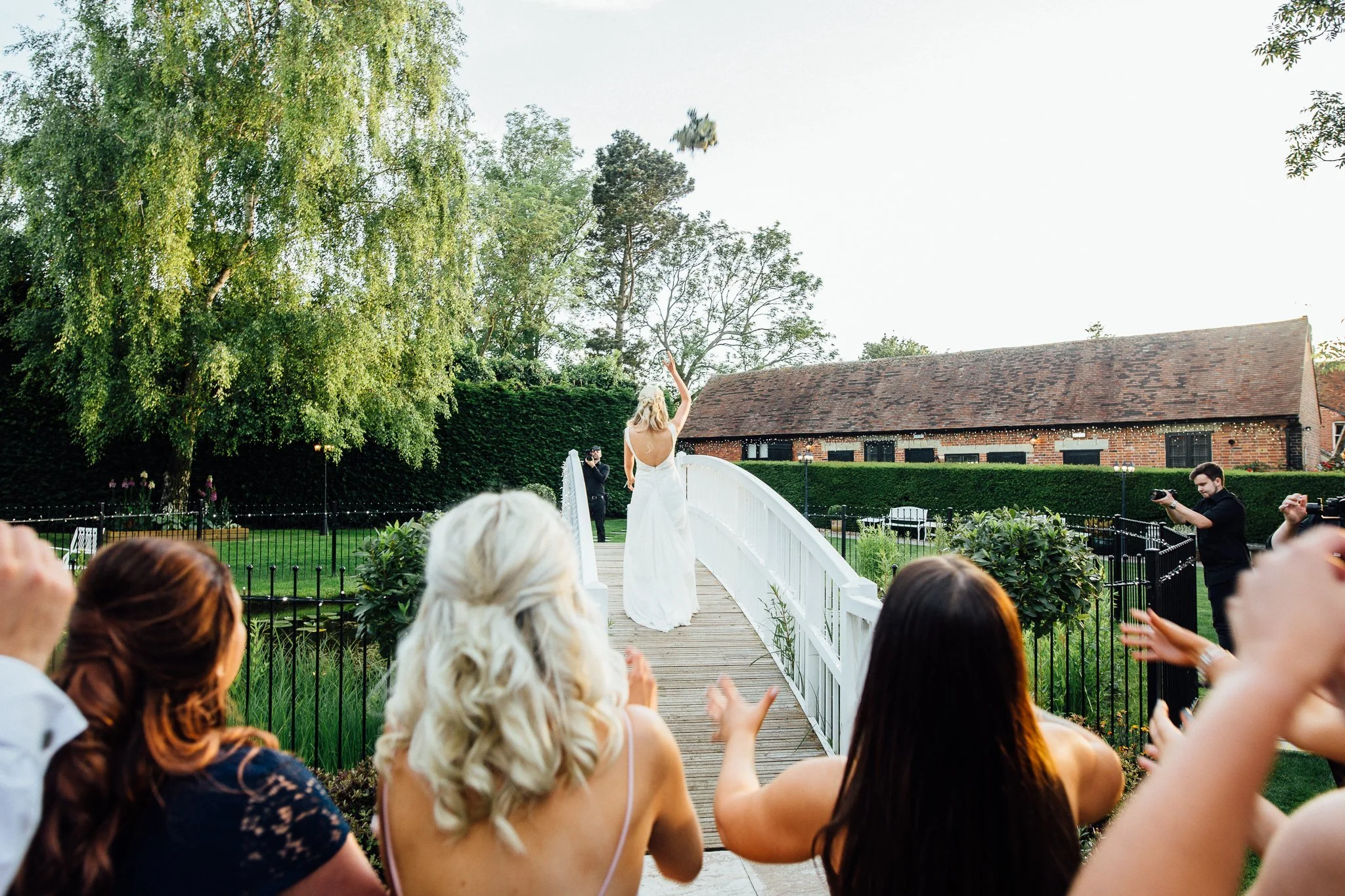  Bride throws bouquet at Winters Barns Wedding Venue Kent 