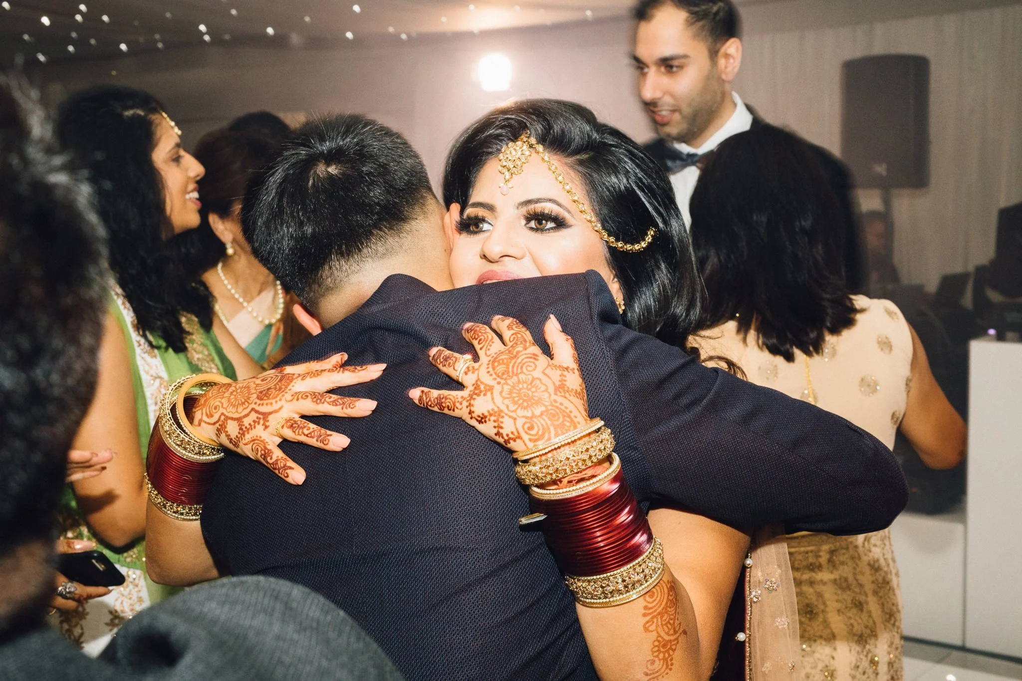  Bride hugging guest on dance floor at Trunkwell House in Berkshire 