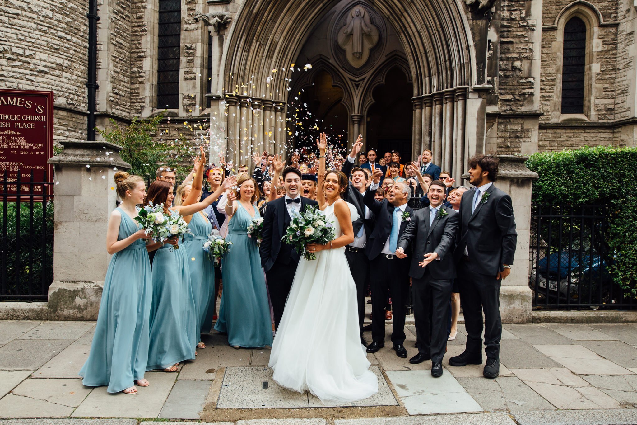  Bride and Groom have confetti thrown at them outside St James Church, Spanish Place Marlyborne 