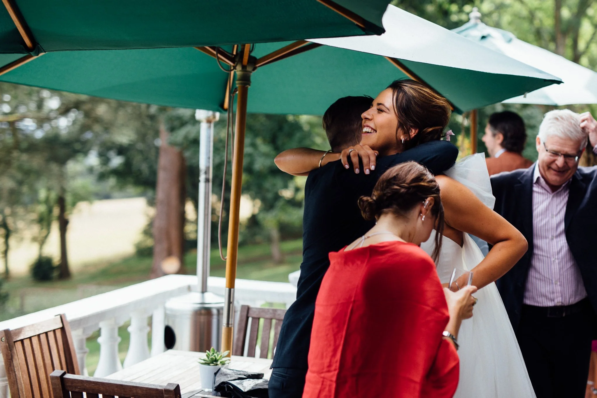  Bride hugging guest at Front of Laura Ashley The Manor Elstree 