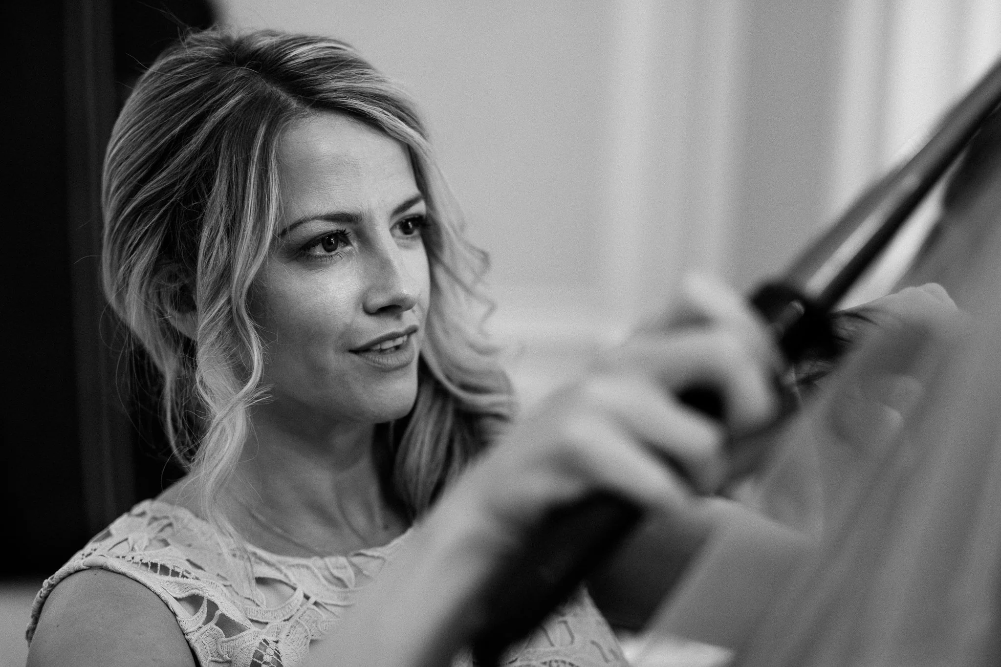 Bridesmaid curling the bride’s hair 