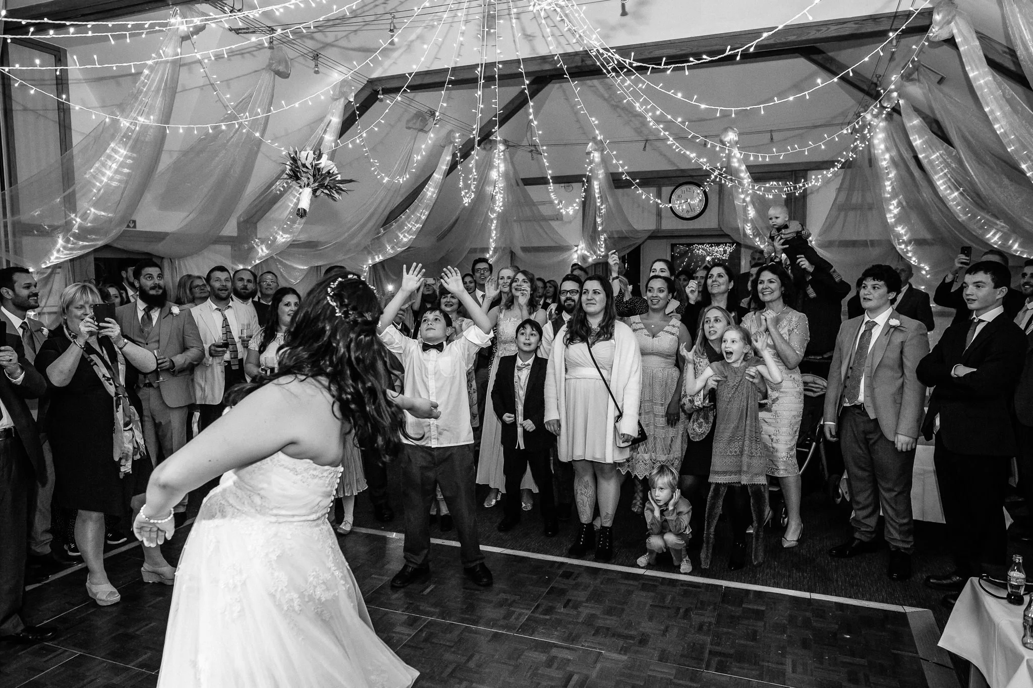  Bride tosses the bouquet at Warren House Hotel Kingston upon Thames 