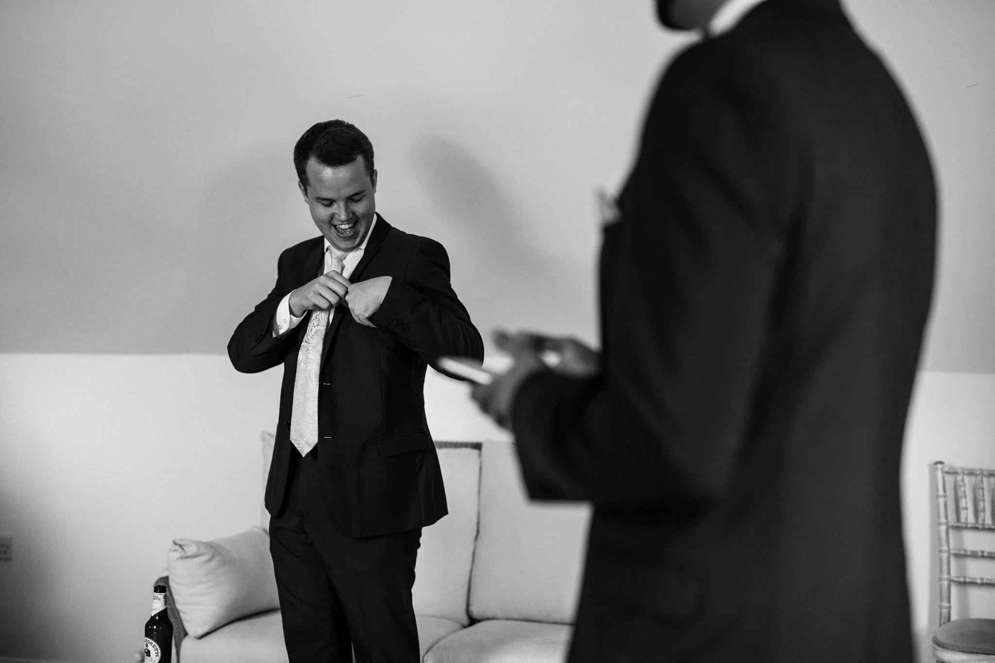  Groomsmen adjusts pocket square 