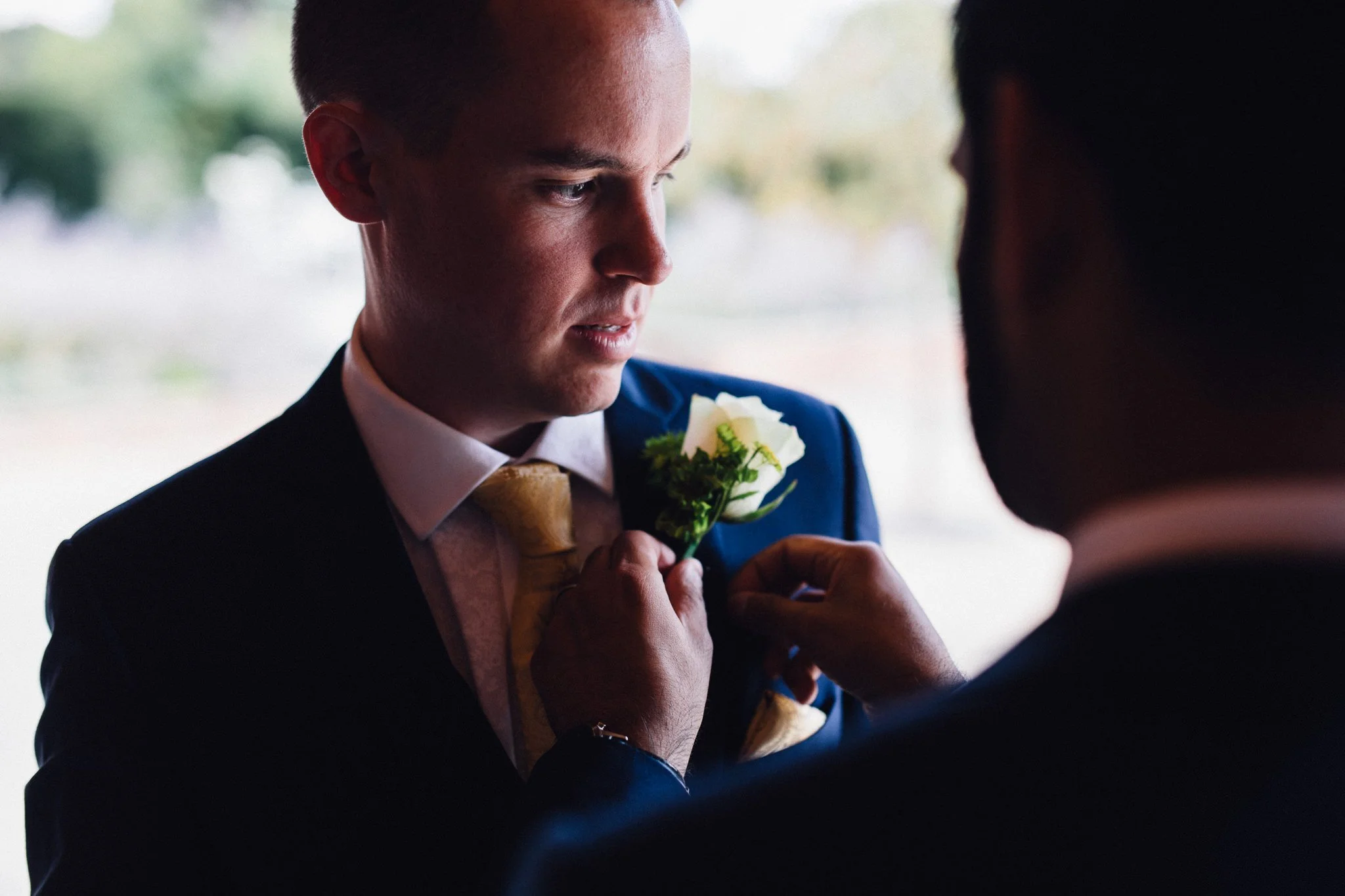  Groom has buttonhole placed 