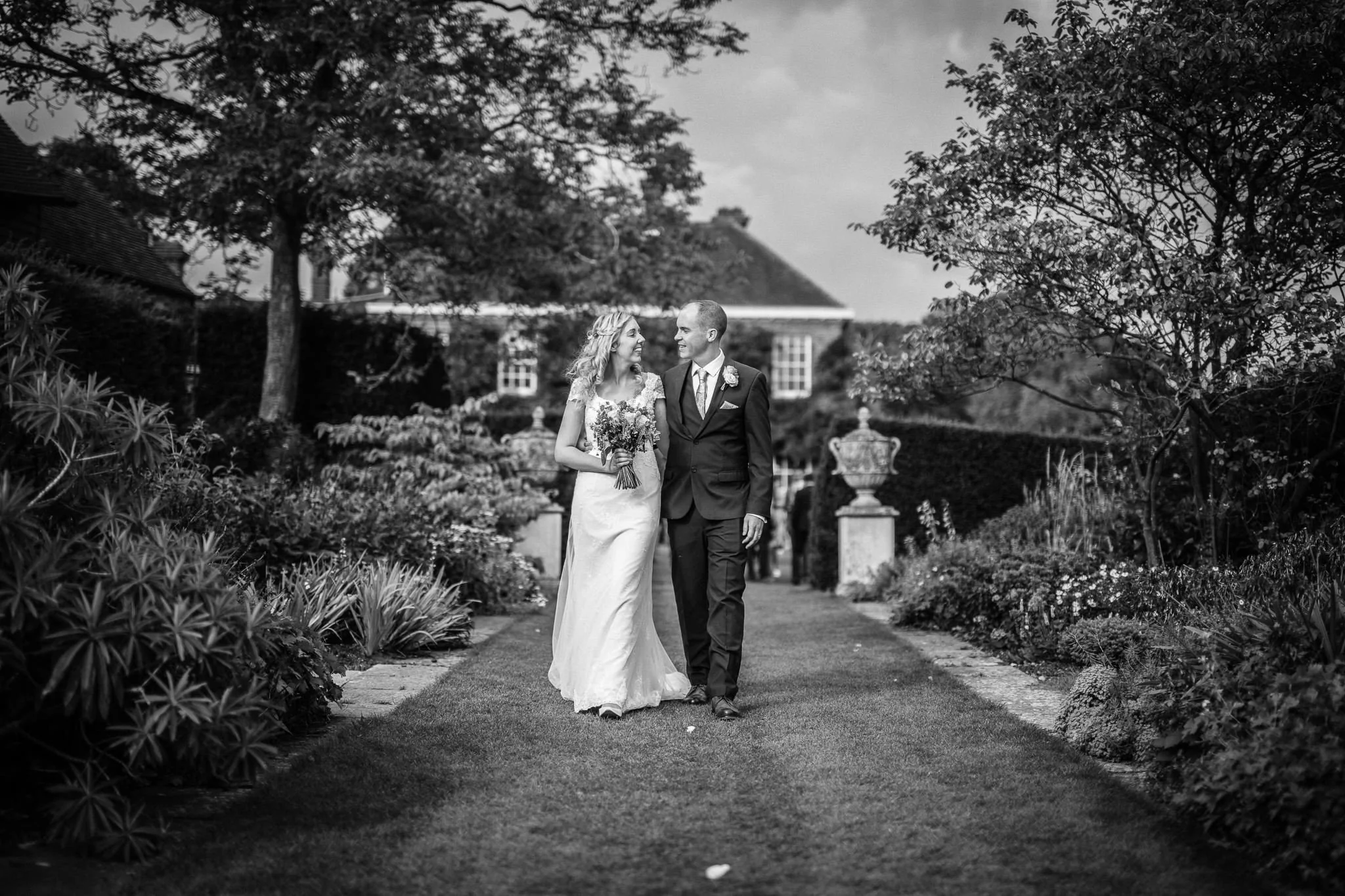  Bride and Groom walk along hugging at Micklefield Hall 
