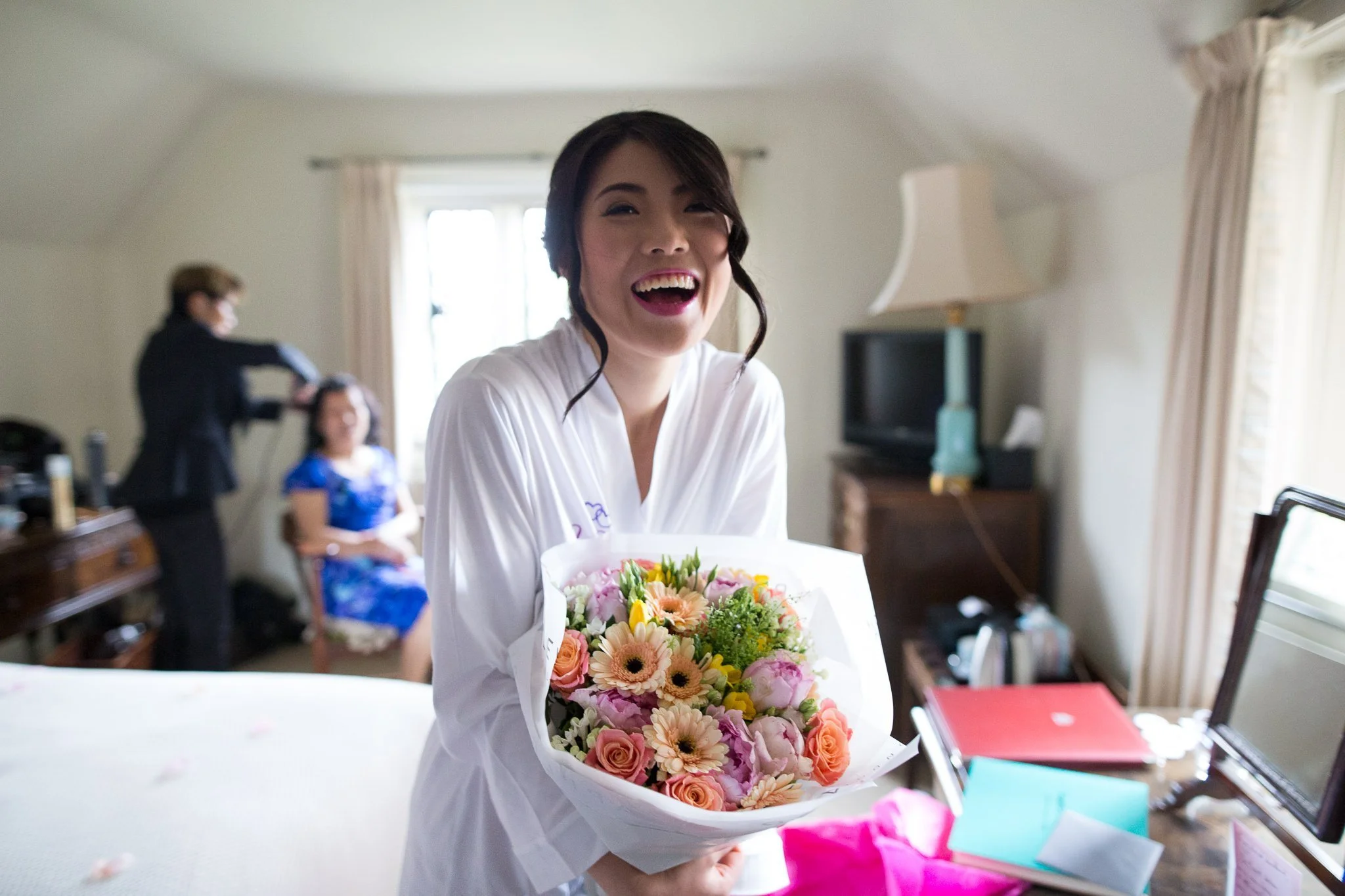  Bride smiling with bouquet of flowers 