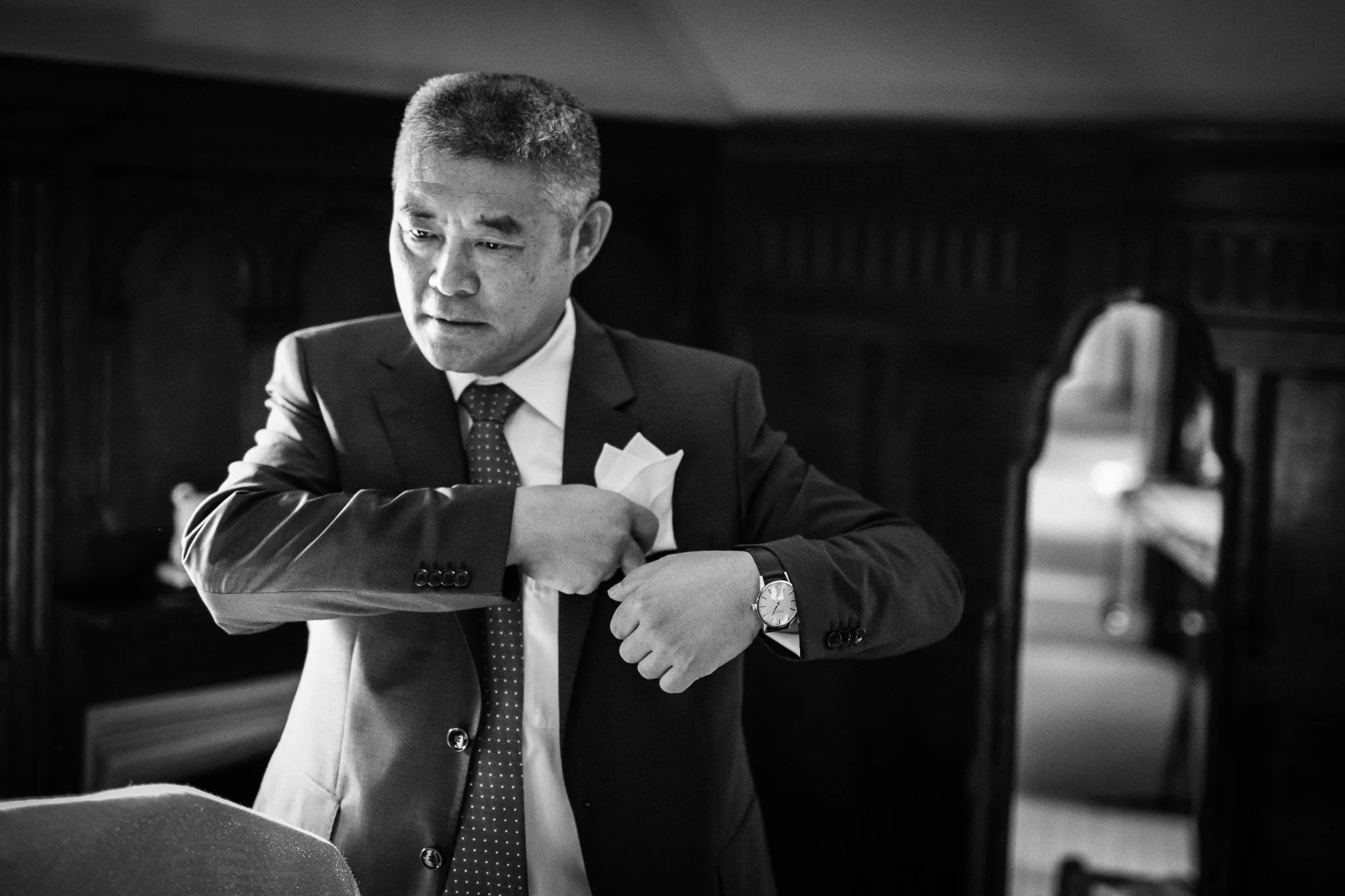 Father of the bride places handkerchief in top pocket 