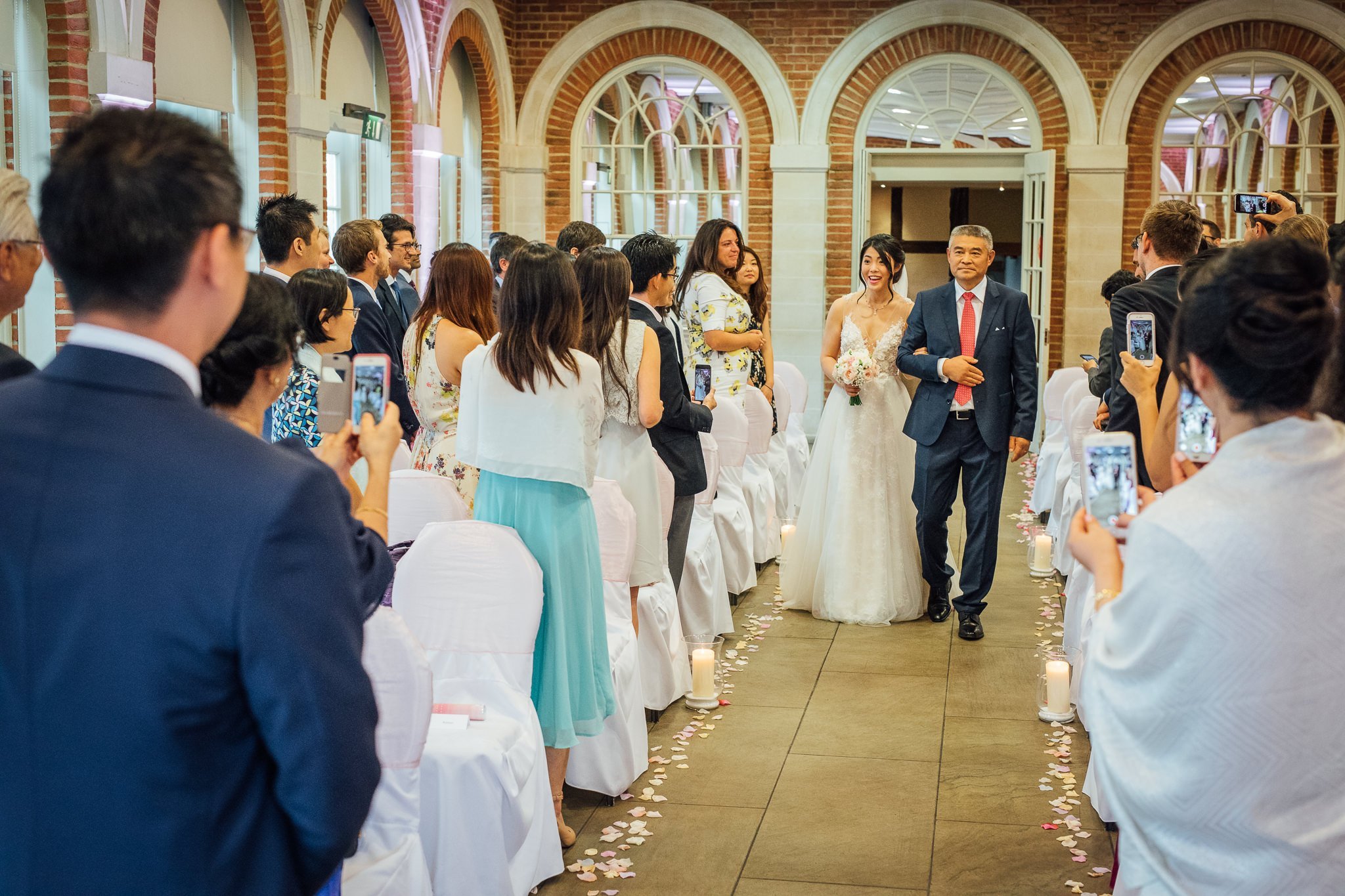  Bride walking down the aisle at Great Fosters Egham 