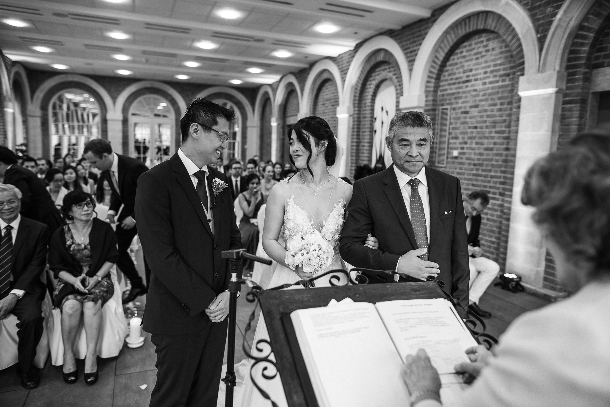  Bride and Groom smiling at each other at Great Fosters Egham 