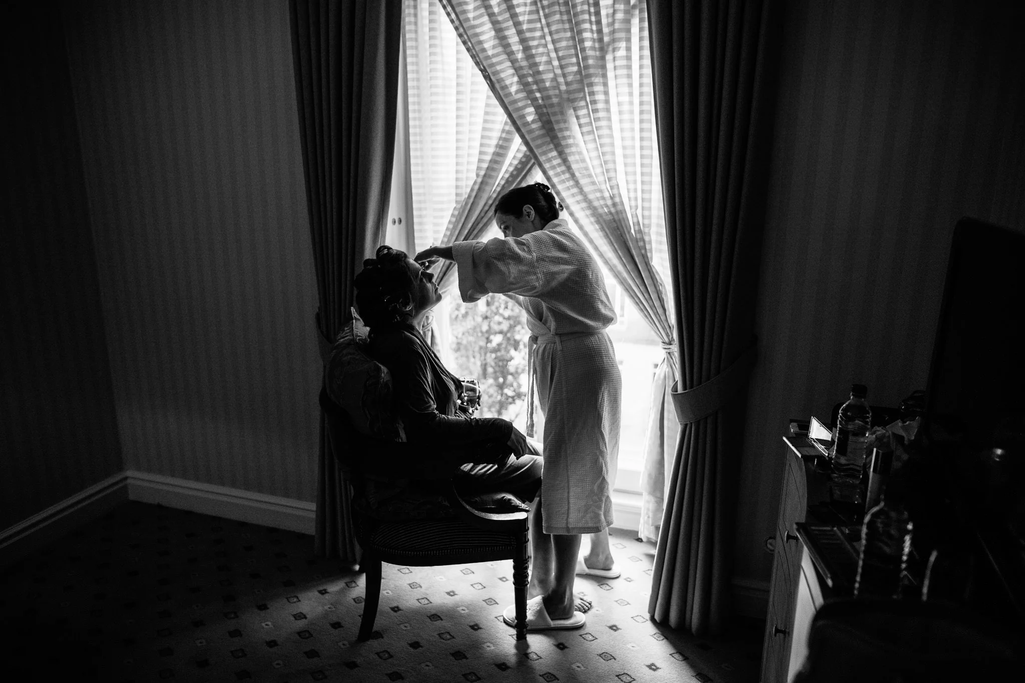  Bridesmaid applies makeup to the Bride 
