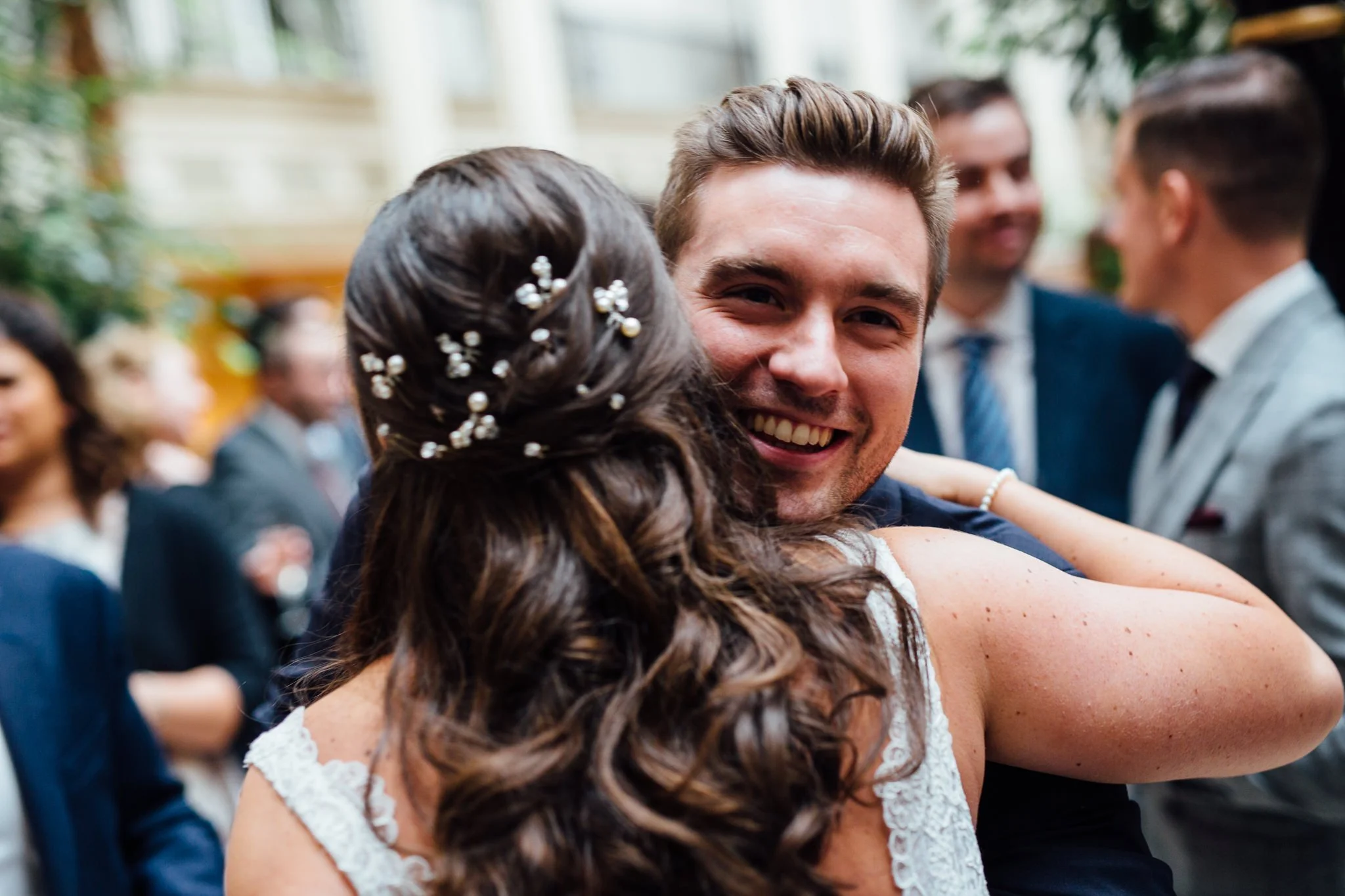  Male guest hugs the Bride 