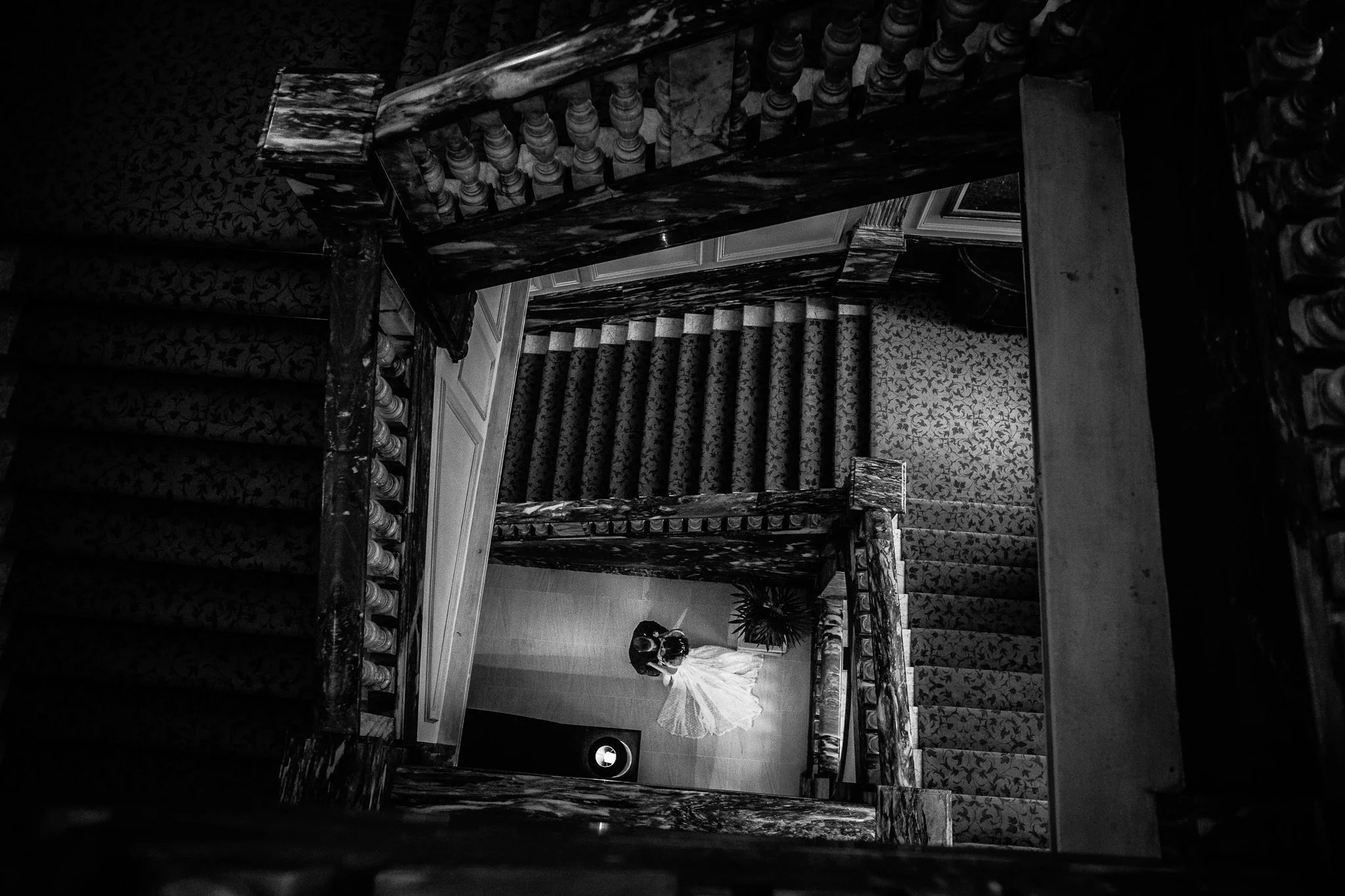  Bride and groom at the bottom of the staircase at The Landmark London hotel 