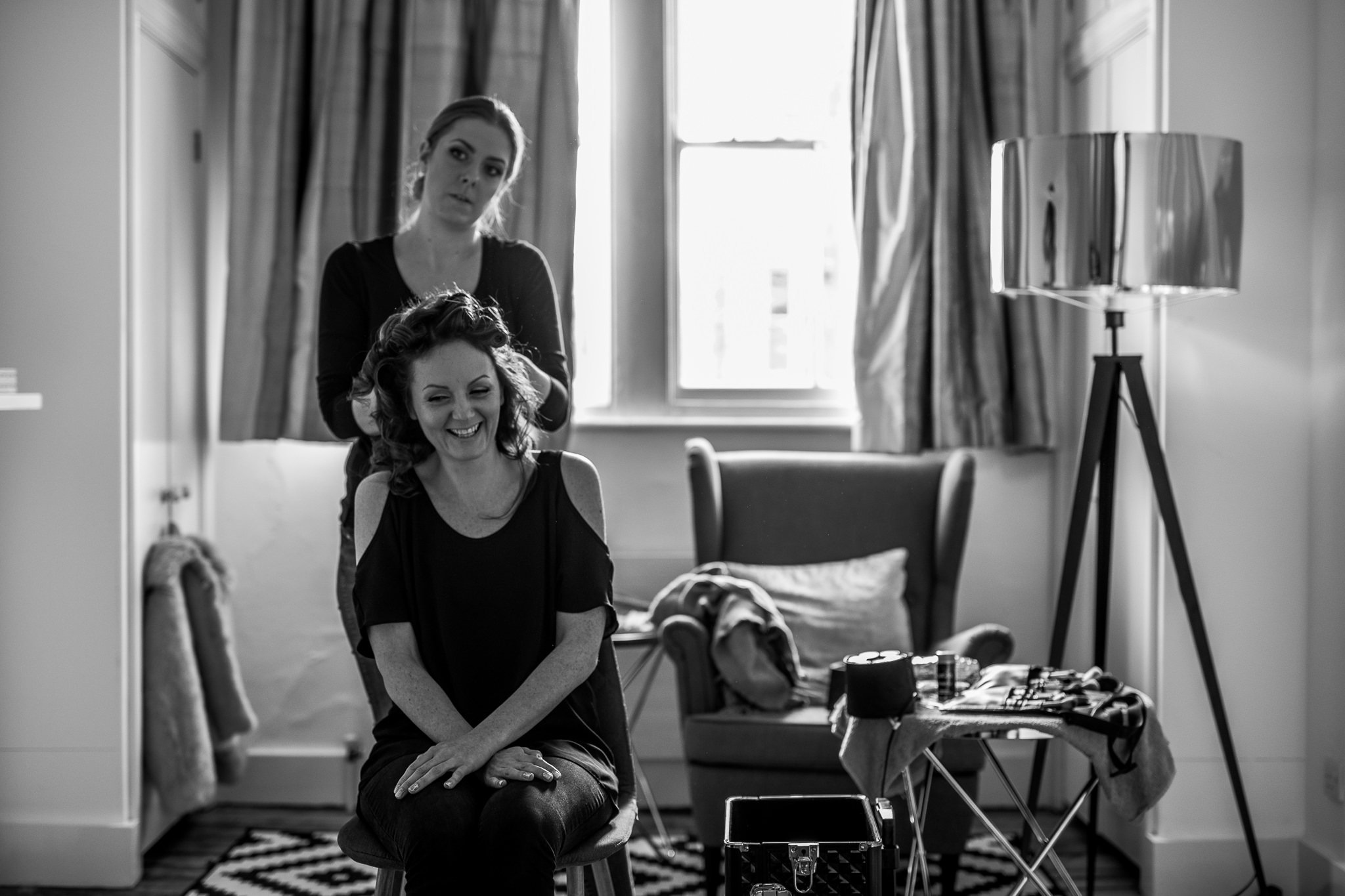  Bride has her hair down on her wedding day whilst laughing 