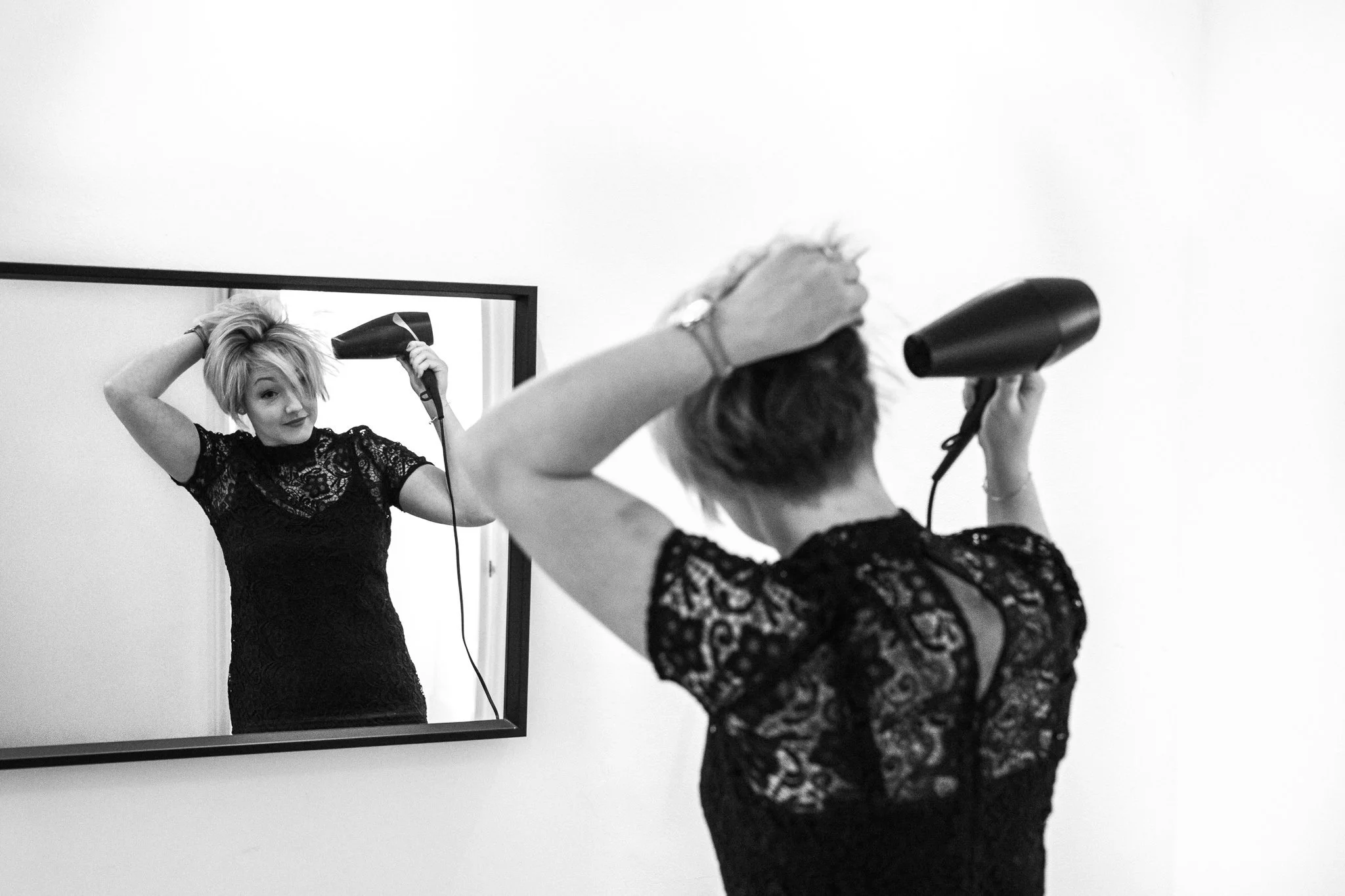  Bridesmaid drys her hair whilst looking in the mirror 
