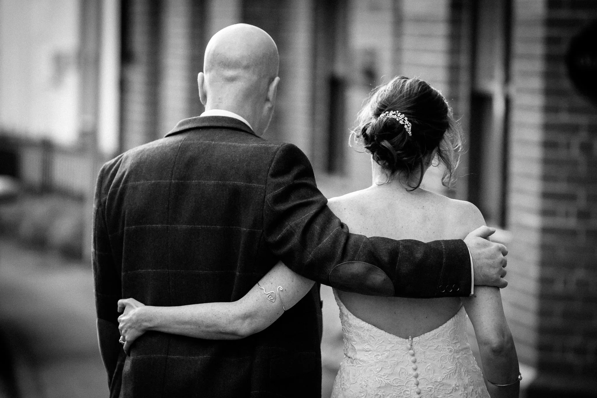  Bride and Groom with their arms around each other 