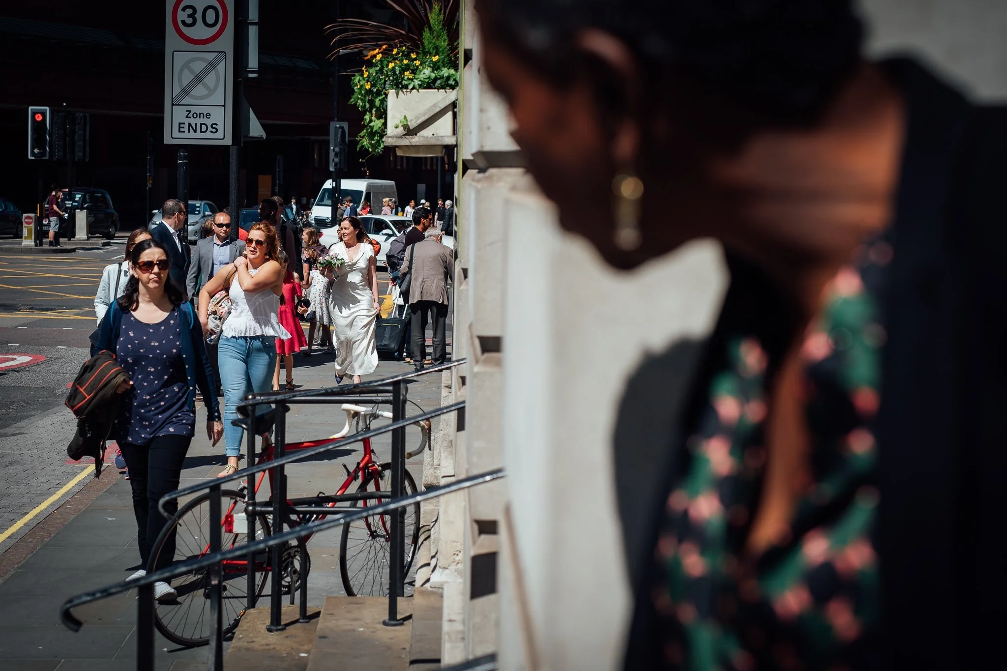  Registrar looks down the street from Camden Town Hall to see the bride arrive 